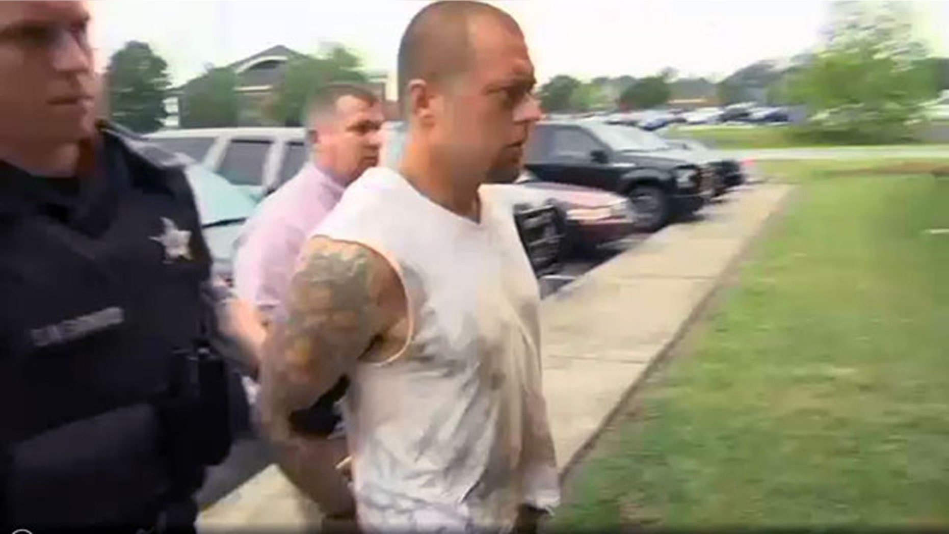 Zachary Powell being taken into custody