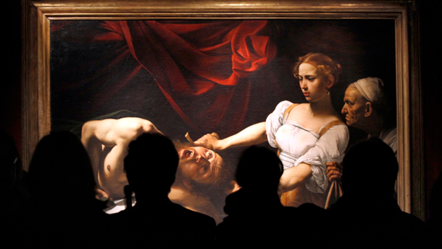 FILE 2010: Visitors stand near Caravaggio's "Judith Beheading Holofernes" painting during an exhibition to celebrate the Baroque master on the 400th anniversary of his death at the Scuderie del Quirinale building in Rome.