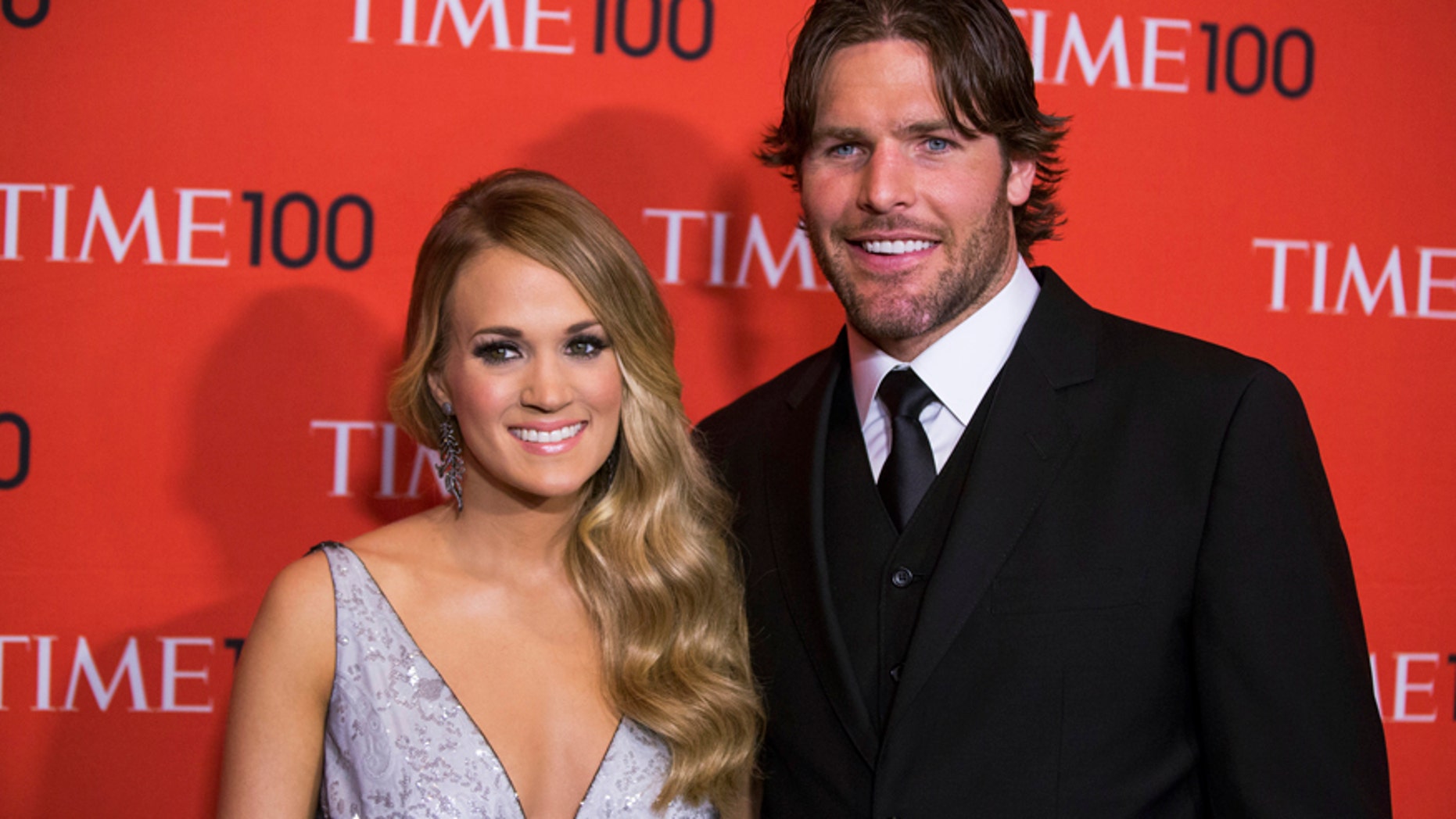 Honoree and singer Carrie Underwood arrives with her husband Mike Fisher at the Time 100 gala celebrating the magazine's naming of the 100 most influential people in the world for the past year, in New York April 29, 2014.