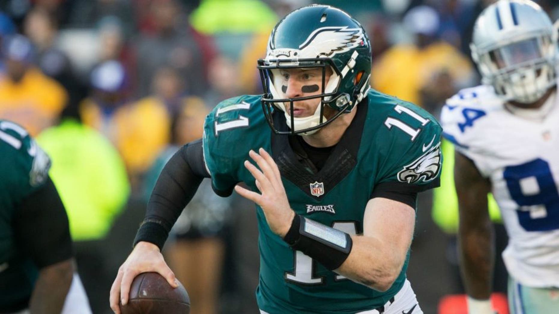 Jan 1, 2017; Philadelphia, PA, USA; Philadelphia Eagles quarterback Carson Wentz (11) runs with the ball against the Dallas Cowboys during the third quarter at Lincoln Financial Field. Mandatory Credit: Bill Streicher-USA TODAY Sports