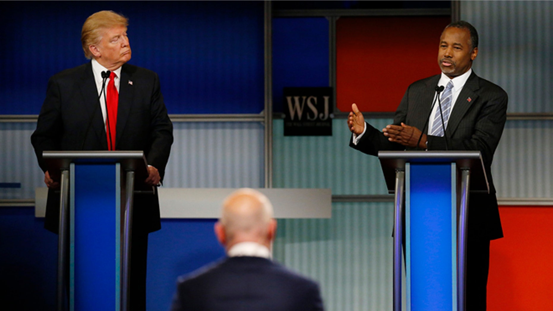 November 10, 2015: Republican U.S. presidential candidate businessman Donald Trump (L) listens as rival candidate Dr. Ben Carson speaks during the debate held by Fox Business Network for the top 2016 U.S. Republican presidential candidates in Milwaukee, Wisconsin. (REUTERS/Jim Young)