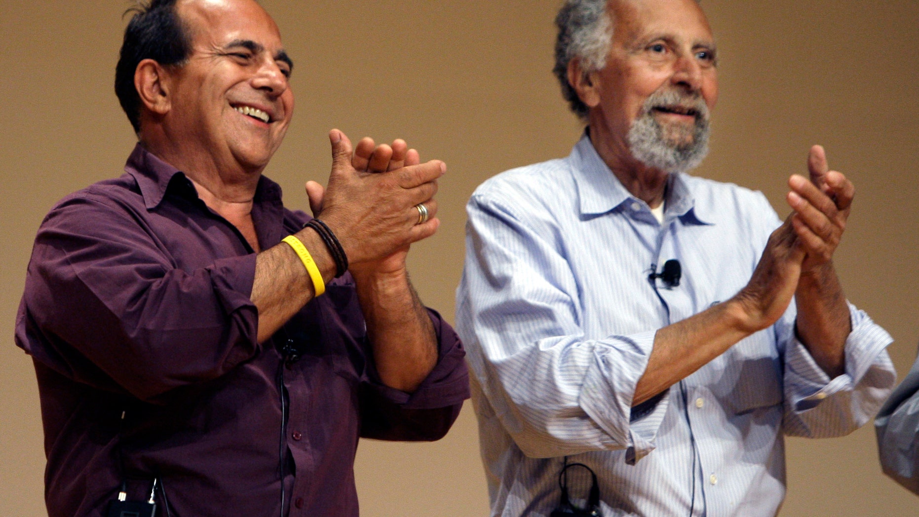 June 19, 2008: In this photo, brothers Ray, left, and Tom Magliozzi, co-hosts of National Public Radio's "Car Talk" show, applaud during a premier of a cartoon show about them in Cambridge, Mass.