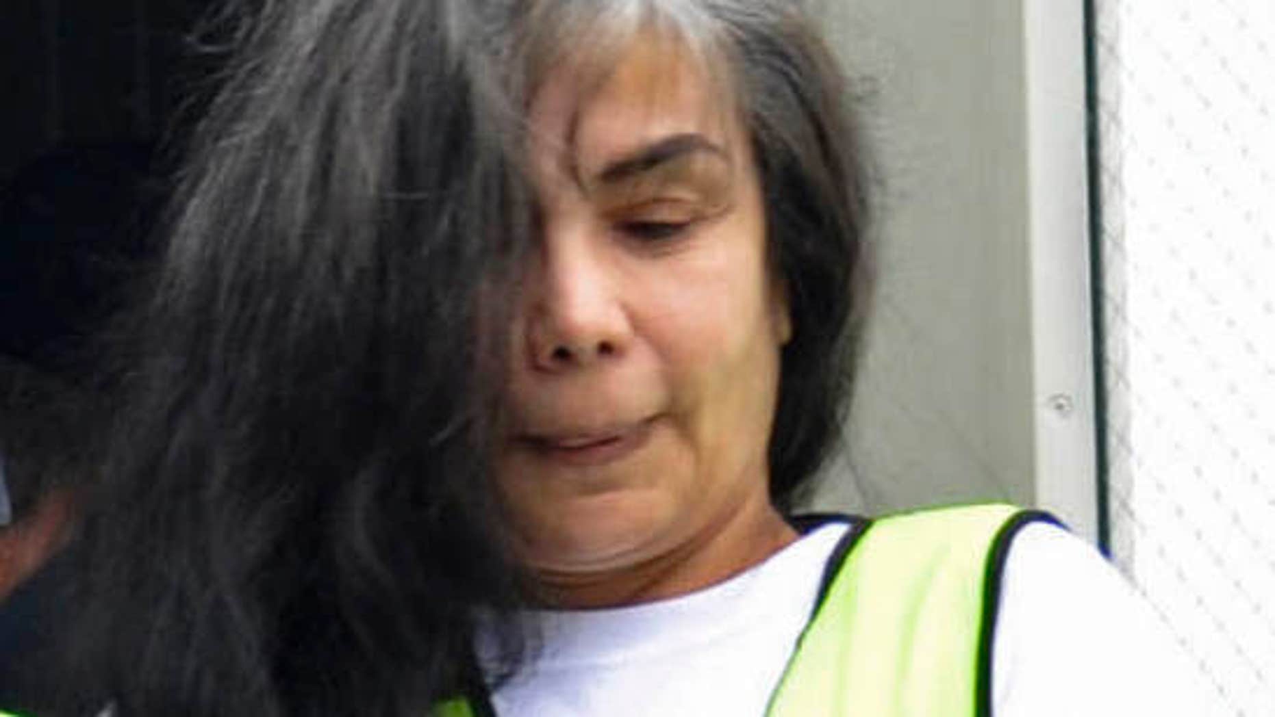 Aug. 20, 2013: Sandra Avila Beltran in handcuffs as she is escorted by federal authorities upon arrival to Benito Juarez airport in Mexico City.