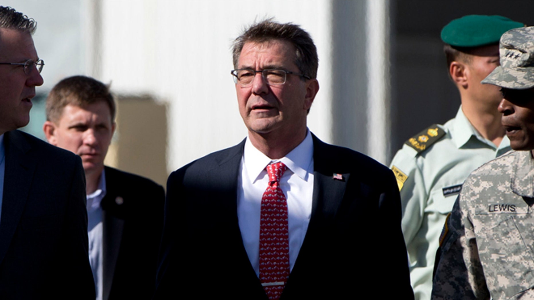 July 23, 2015: U.S. Defense Secretary Ash Carter, joined by U.S. Army Lt. Gen. Ron Lewis, right, and Chief of Staff Eric Rosenbach, left, walks the tarmac before boarding his plane at Queen Alia Airport in Amman, Jordan, en route to Baghdad, Iraq.