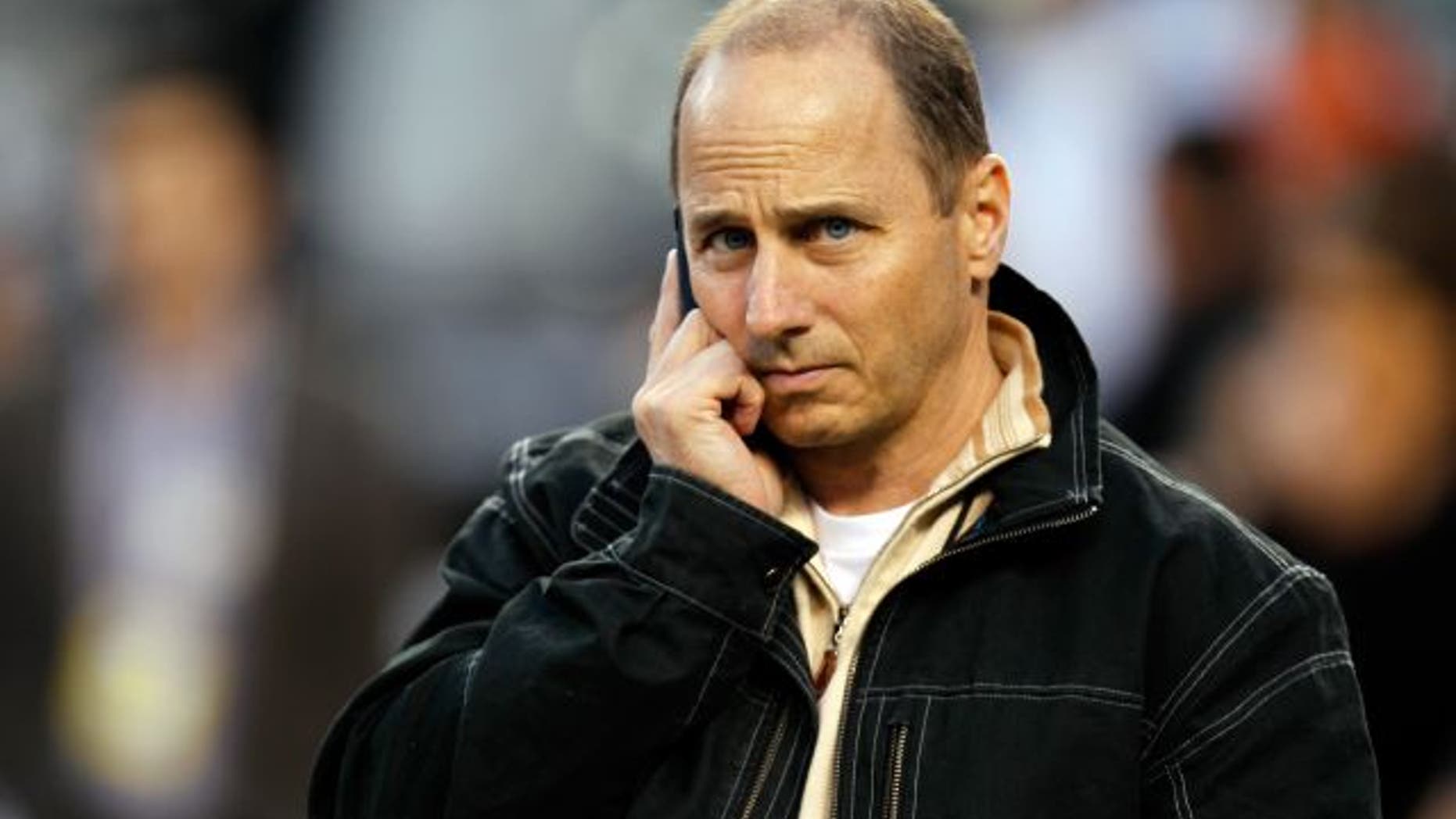 DETROIT, MI - OCTOBER 17: New York Yankees general manager Brian Cashman talks on the phone on the field during batting practice against the Detroit Tigers during game four of the American League Championship Series at Comerica Park on October 17, 2012 in Detroit, Michigan. (Photo by Gregory Shamus/Getty Images)