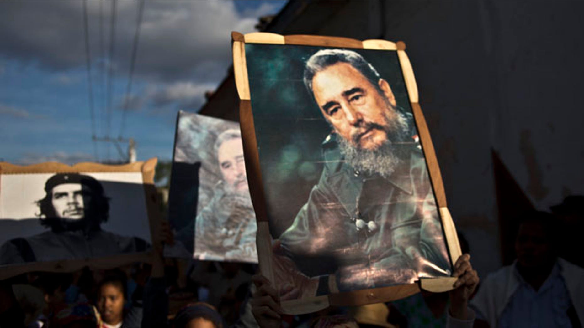 Jan. 8, 2015: Children carry framed images of Fidel Castro and Che Guevara in a caravan tribute marking the 56th anniversary of the original street party that greeted a triumphant Castro and his rebel army.