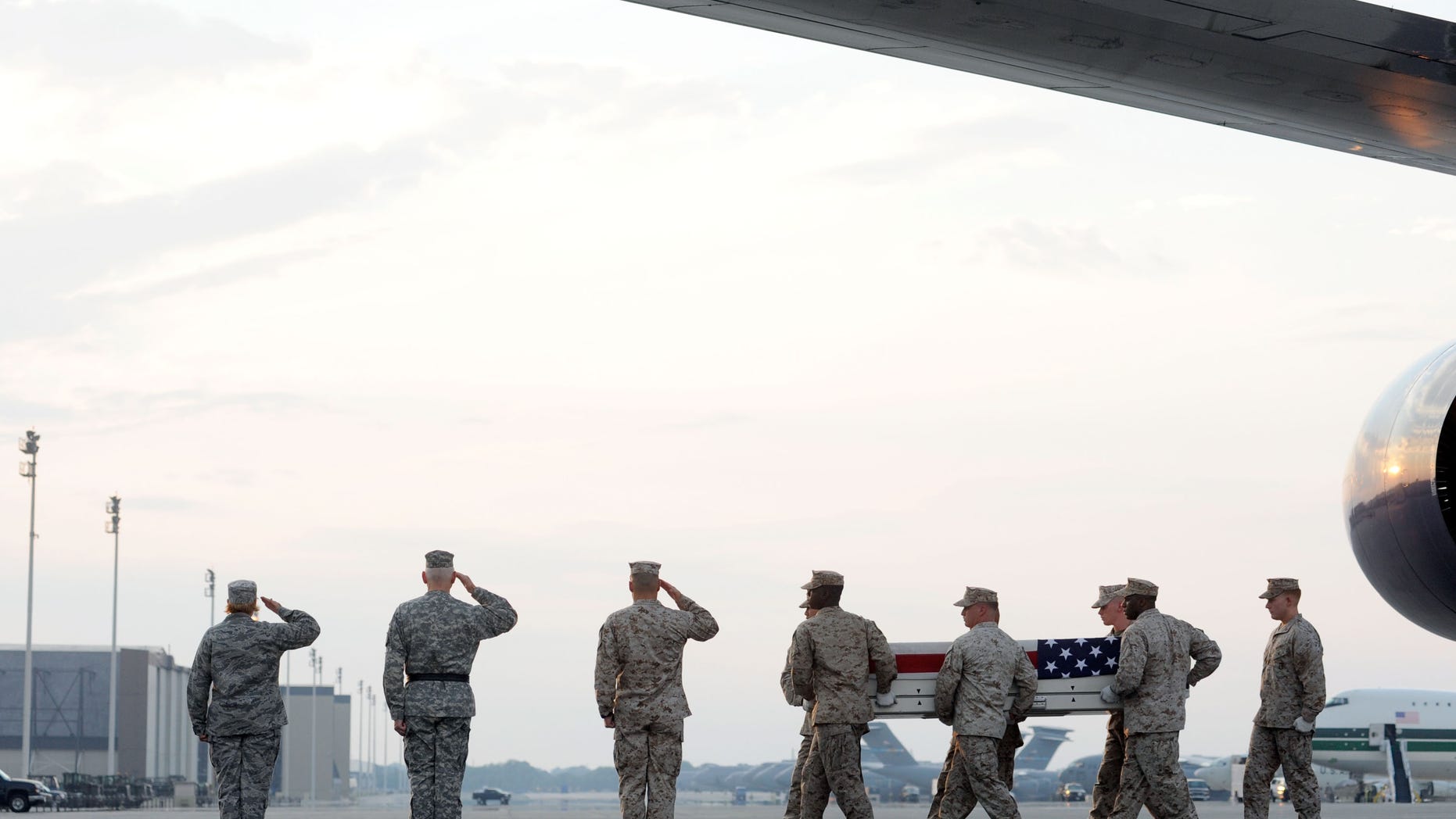 Aug. 9: A Marine carry team moves a transfer case containing the remains of Sgt. Adan Gonzales Jr. at Dover Air Force Base, Del. According to the Department of Defense, Gonzales, 28, of Bakersfield, Calif., died Aug. 7, 2011 while conducting combat operations in Helmand province, Afghanistan.