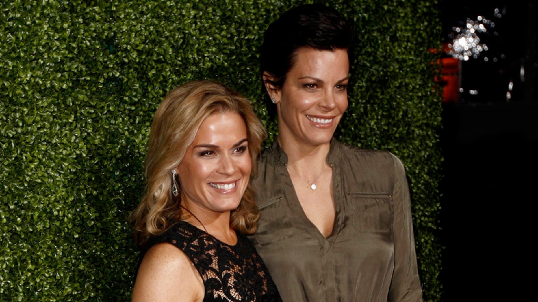 FILE - In this Jan. 6, 2011 file photo, Cat Cora, left, and Jennifer Cora arrive at the Oprah Winfrey Network Television Critics Association 2011 Winter Press Tour Cocktail Reception in Pasadena, Calif. Cat Cora announced Monday, Nov. 9, 2015, that she and her partner of 17 years, Jennifer Cora, are divorcing and plan to jointly raise their four sons. Court records in Santa Barbara, California, show the pair filed for divorce in late October 2015. (AP Photo/Matt Sayles, File)