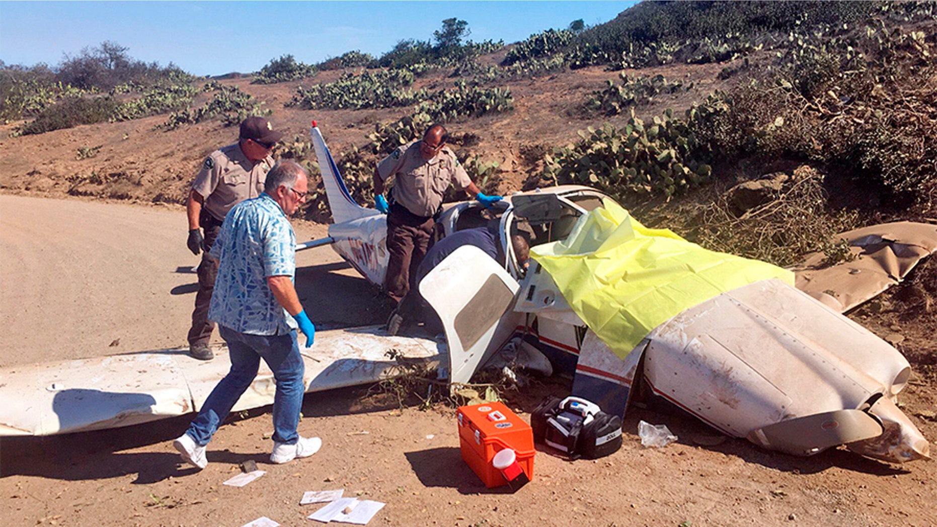 First responders examine the scene of a plane crash at the airport near Avalon on Santa Catalina Island off the Southern California coast on Wednesday.
