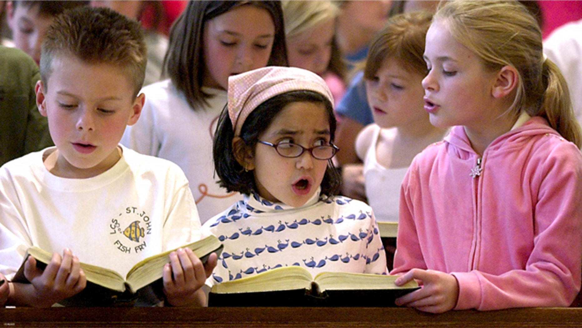 FILE: Catholic school students in Kansas sing at a prayer service.