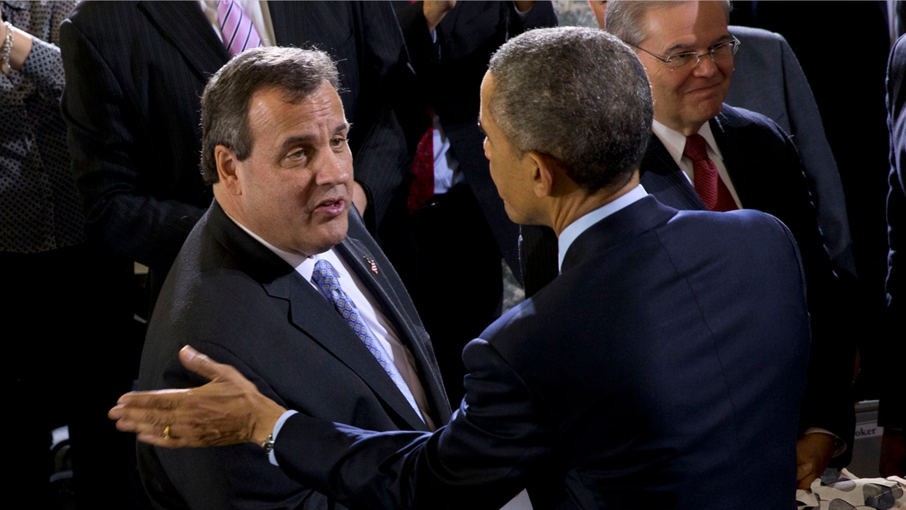 President Barack Obama talks with New Jersey Gov. Chris Christie after speaking to troops at Joint Base McGuire-Dix-Lakehurst, N.J., Monday, Dec. 15, 2014. Christie is joined by Sen. Cory Booker, D-N.J., right and Sen. Robert Menendez, D-N.J., second from right. (AP Photo/Jacquelyn Martin)
