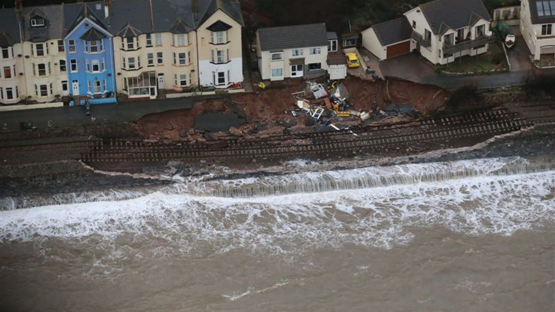 In this undated picture provided by National Rail, a railway line severely damaged by the high seas caused by winter storms is seen in Dawlish, Devon, England. Engineers have been working through the night at Dawlish to shore up a seriously damaged section of sea wall before another Atlantic storm system arrives on Saturday. The damaged railway line has meant much of Devon and Cornwall has been cut off from the rest of the country by rail. (AP Photo/Network Rail) UNITED KINGDOM OUT - NO SALES - NO ARCHIVES