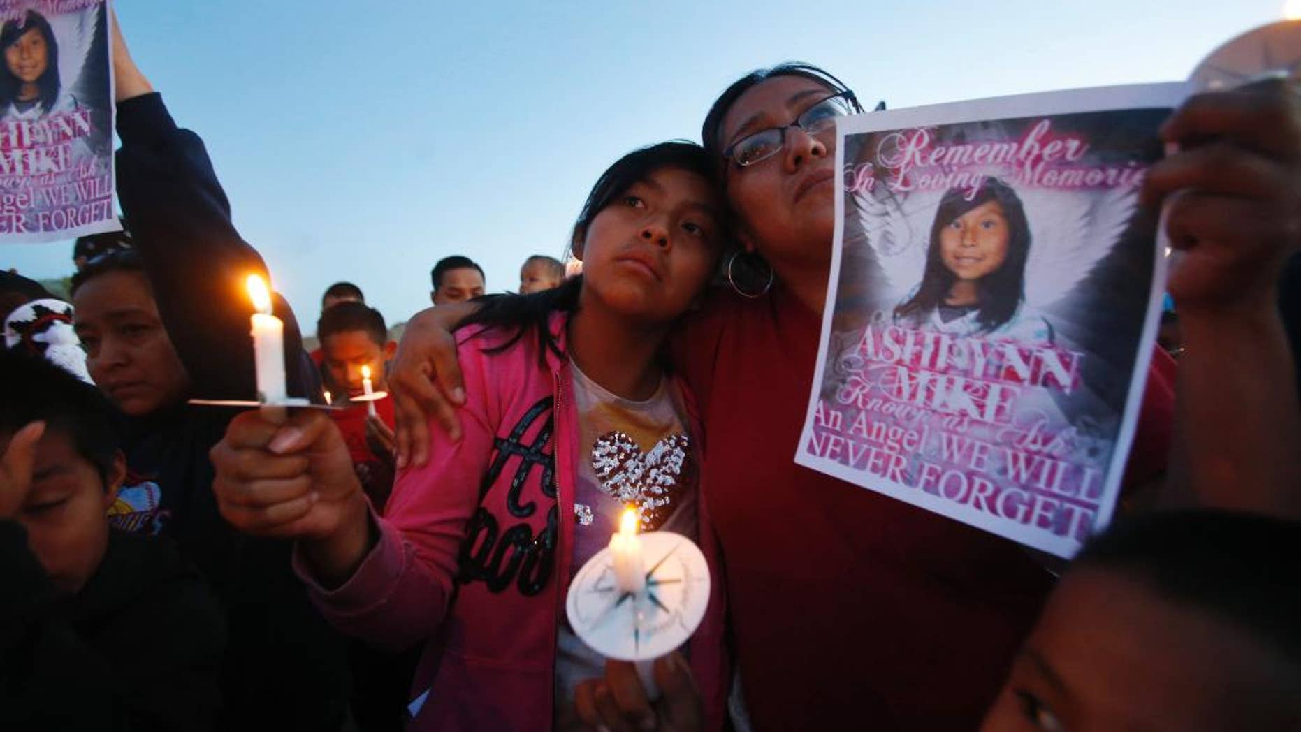 May 4, 2016: Klandre Willie, left, and her mother, Jaycelyn Blackie, participate in a candlelight vigil for Ashlynne Mike at the San Juan Chapter House in Lower Fruitland, N.M. The FBI said Ashlynne was abducted after school and her body was found the next day. The death of the young Navajo Nation girl is fueling efforts to create an Amber Alert plan on the vast reservation.