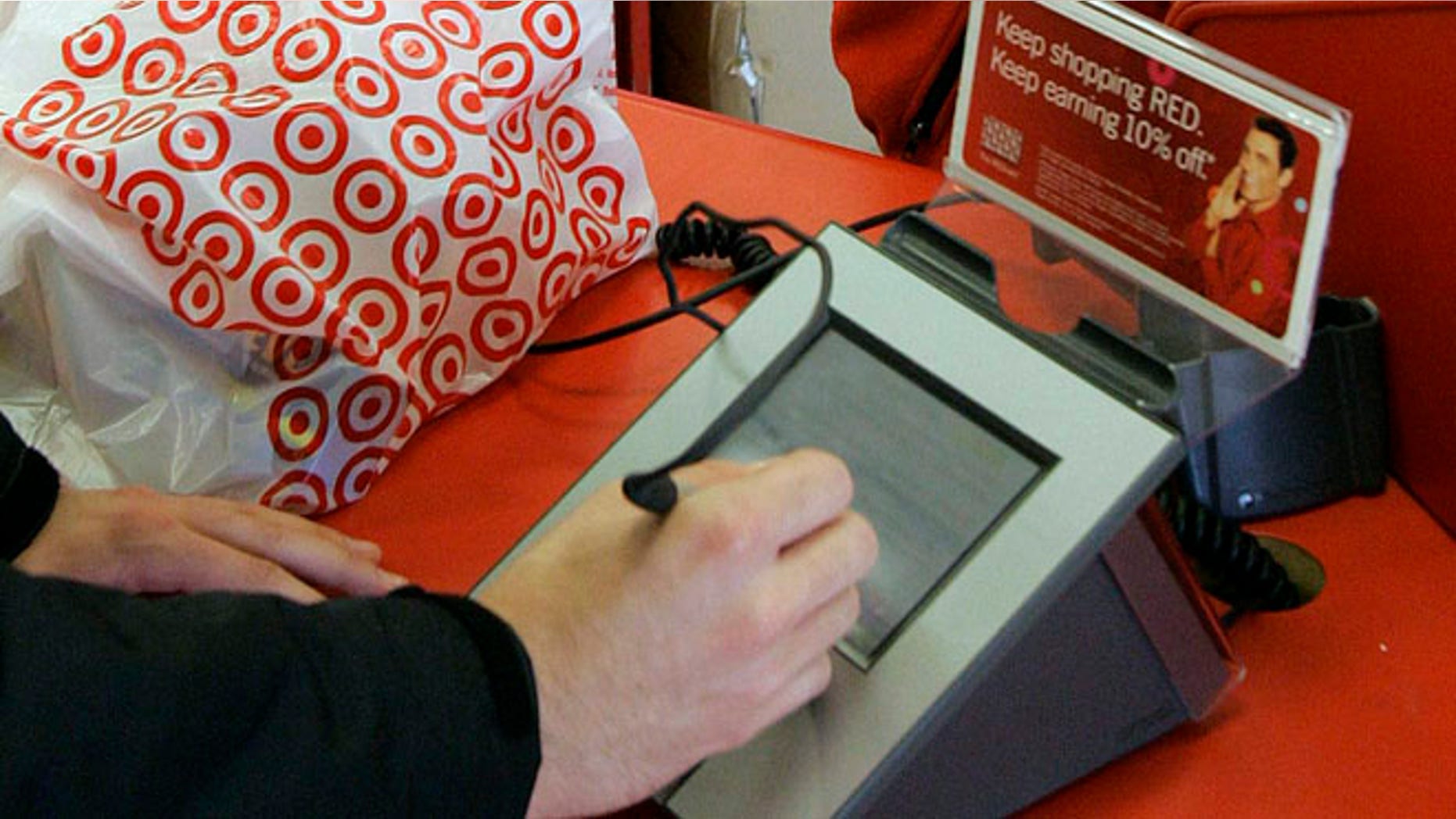 In this Jan. 18, 2008 file photo, a customer signs his credit card receipt at a Target store in Tallahassee, Fla. The U.S. is the juiciest target for hackers hunting credit card information. And experts say incidents like the recent data theft at Target's stores will get worse before they get better. That's in part because U.S. credit and debit cards rely on an easy-to-copy magnetic strip on the back of the card, which stores account information using the same technology as cassette tapes.
