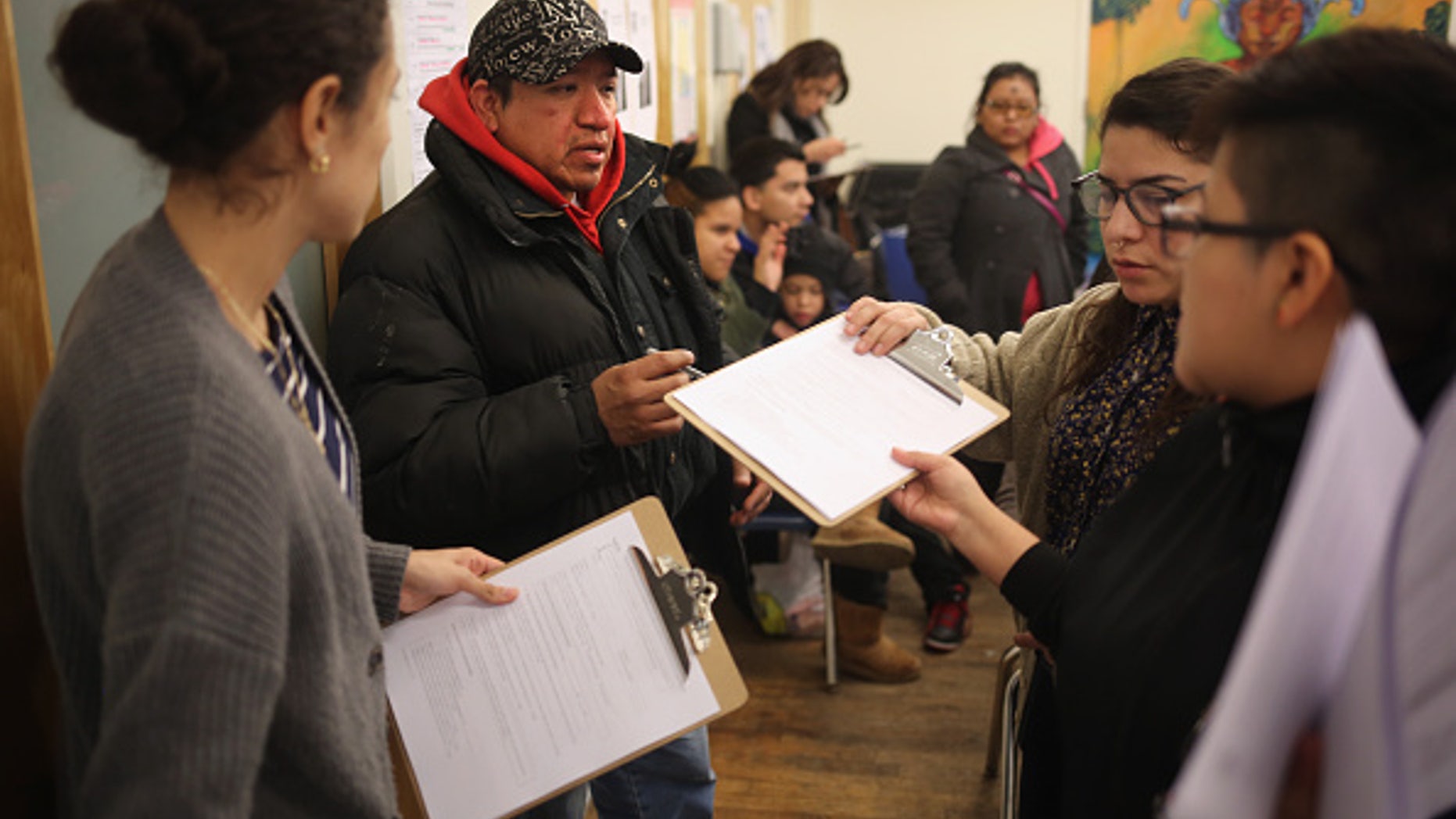 NEW YORK, NY - FEBRUARY 18: Immigrants fill out forms for Deferred Action for Childhood Arrivals (DACA), at a workshop on February 18, 2015 in New York City. The immigrant advocacy group Make the Road New York holds weekly workshops to help immigrants get legal status under DACA to work in the United States. An expansion of the national program, scheduled for this week, was frozen by a ruling from a Texas federal judge. The Obama Administration plans to appeal the ruling and, if sussessful, DACA would allow legalization of up to two million immigrants who entered the United States before they were age 16. (Photo by John Moore/Getty Images)