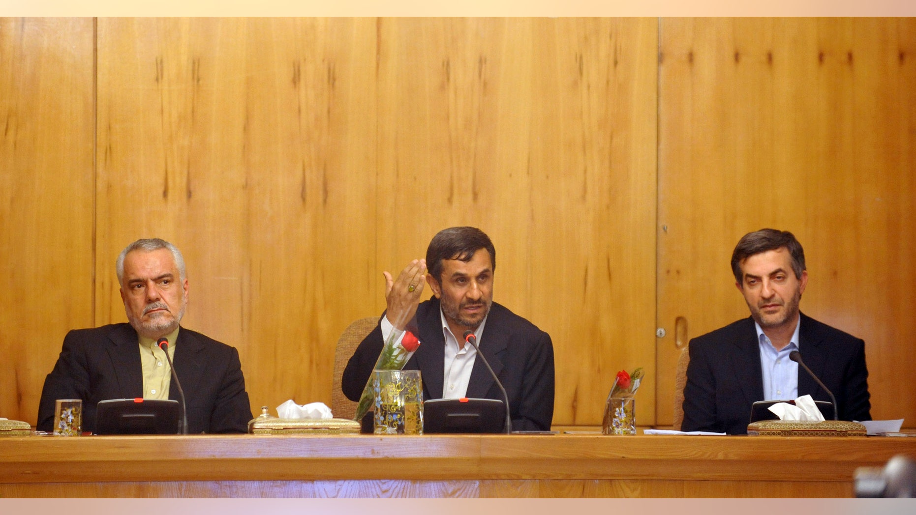 In this Sunday, May 1, 2011 file photo, Iranian President Mahmoud Ahmadinejad, center, speaks, as his office director, Esfandiar Rahim Mashaei, right, and Vice-President Mohammad Reza Rahimi, listen, in a cabinet meeting, in Tehran, Iran. (AP/IIPA/File)