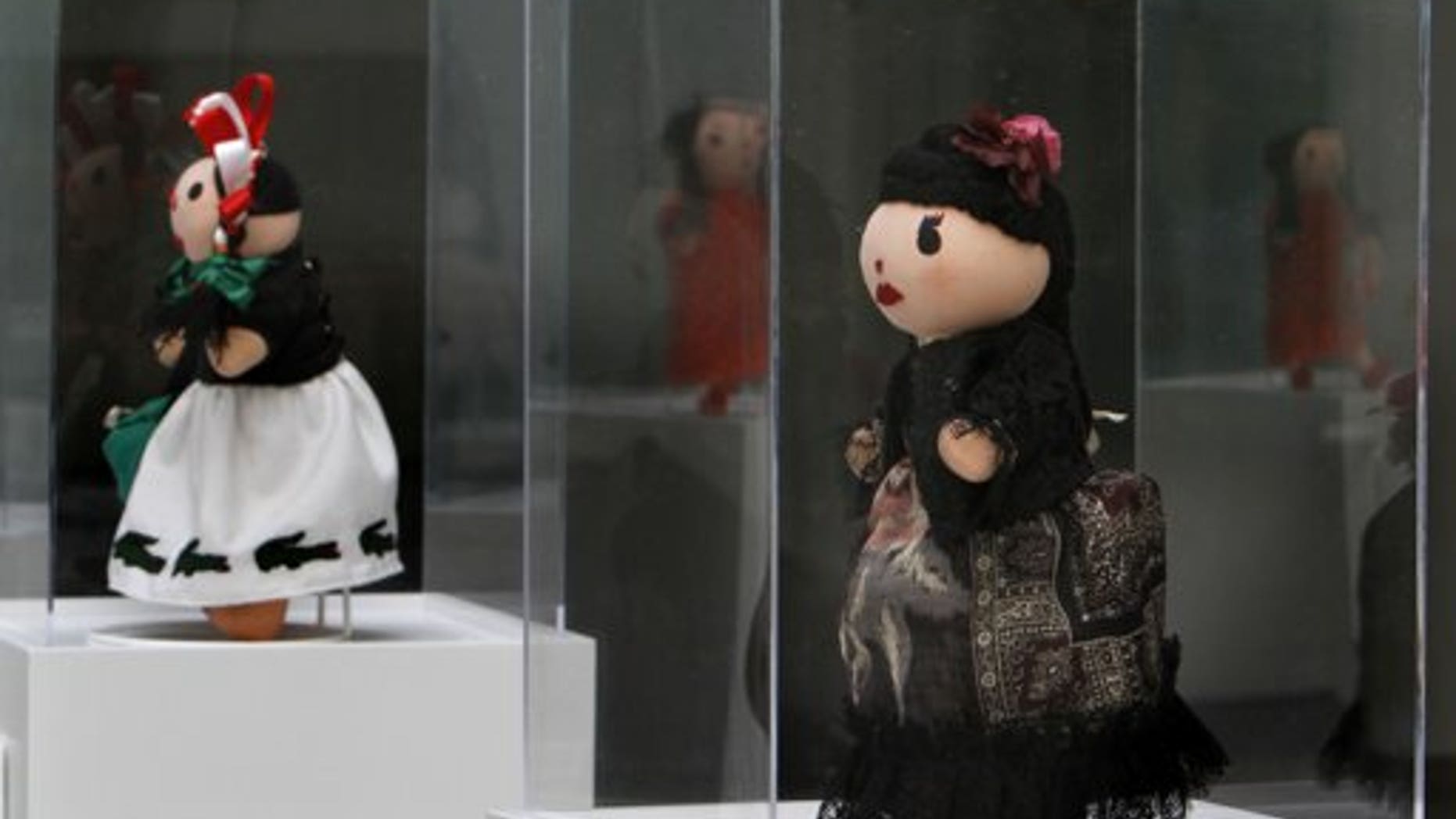 Sept. 9: Traditional Mexican Maria Dolls dressed by French label Kenzo, right, and Lacoste, left, are on display at the Museum of Folk Art in Mexico City. For the first time, Mexico City has joined the global Fashion's Night Out.