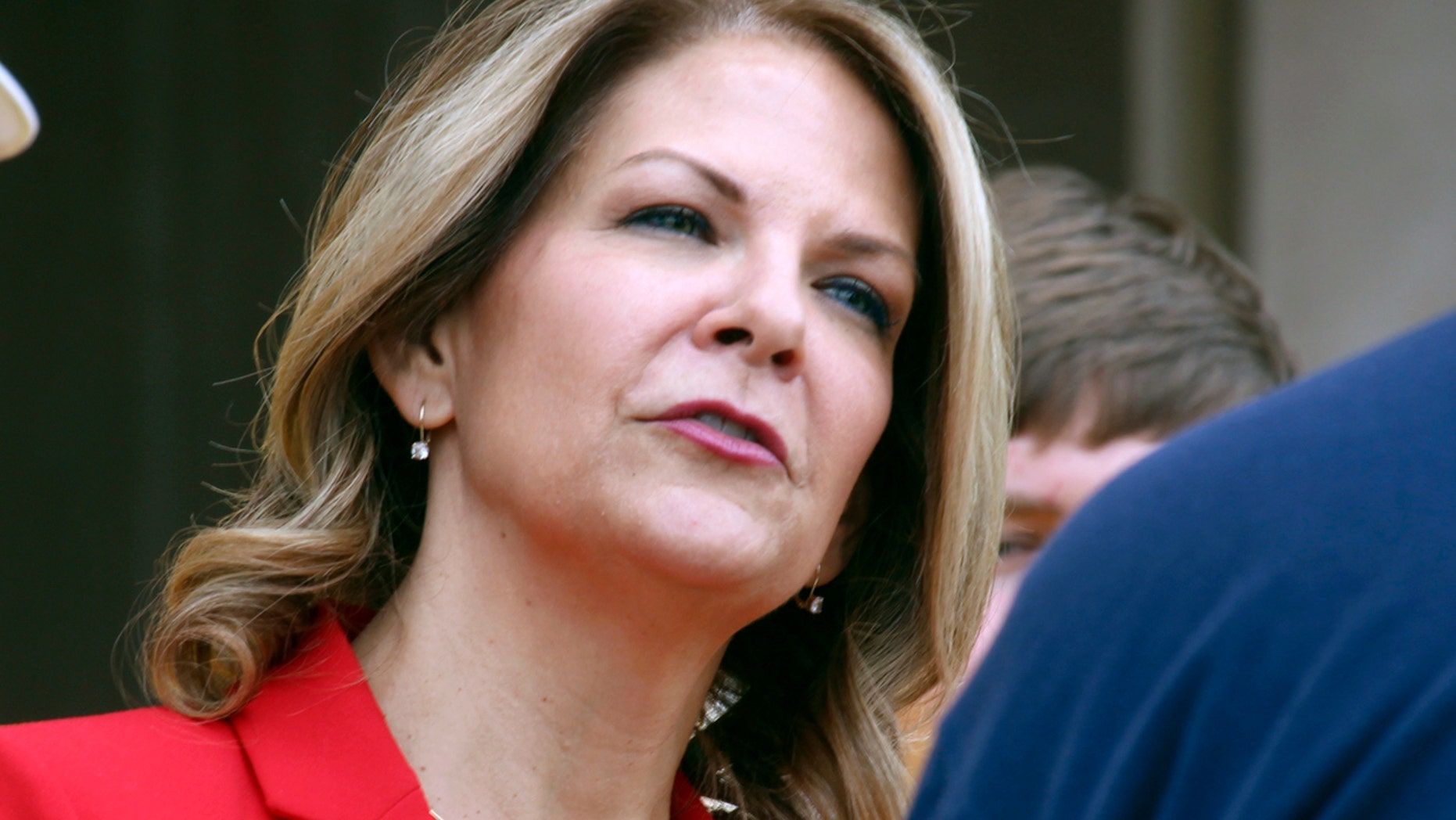 FILE: Kelli Ward speaks to the media as she prepares to file her nominating petitions at the state Capitol in Phoenix