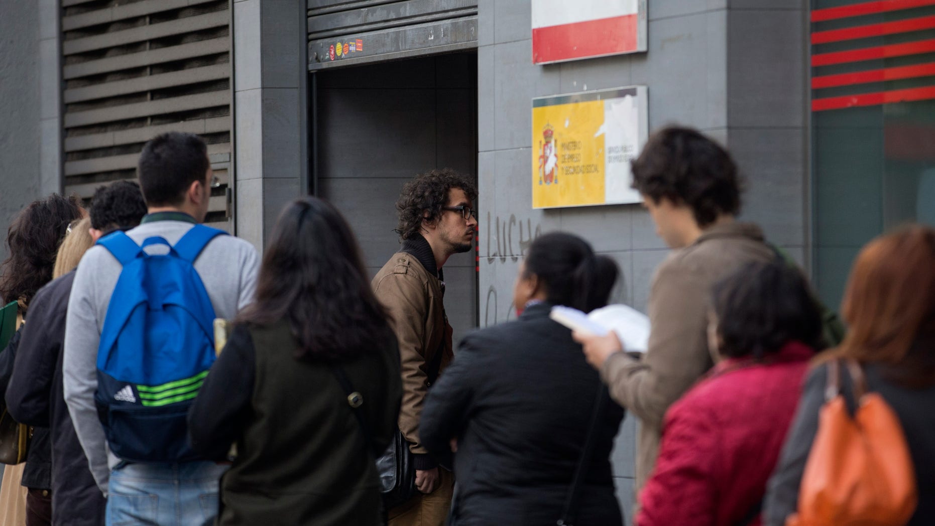 People queue to enter a government unemployment office in Madrid, Spain, Tuesday Oct. 5, 2013. The number of people registered as unemployed in Spain rose by a little over 87,000 in October as many jobs created in the summer tourist season come to an end. The increase comes amid some hopeful signs over Spain's economy with a two-year recession coming to an end in the third quarter, albeit with modest quarterly growth of 0.1 percent. (AP Photo/Paul White)