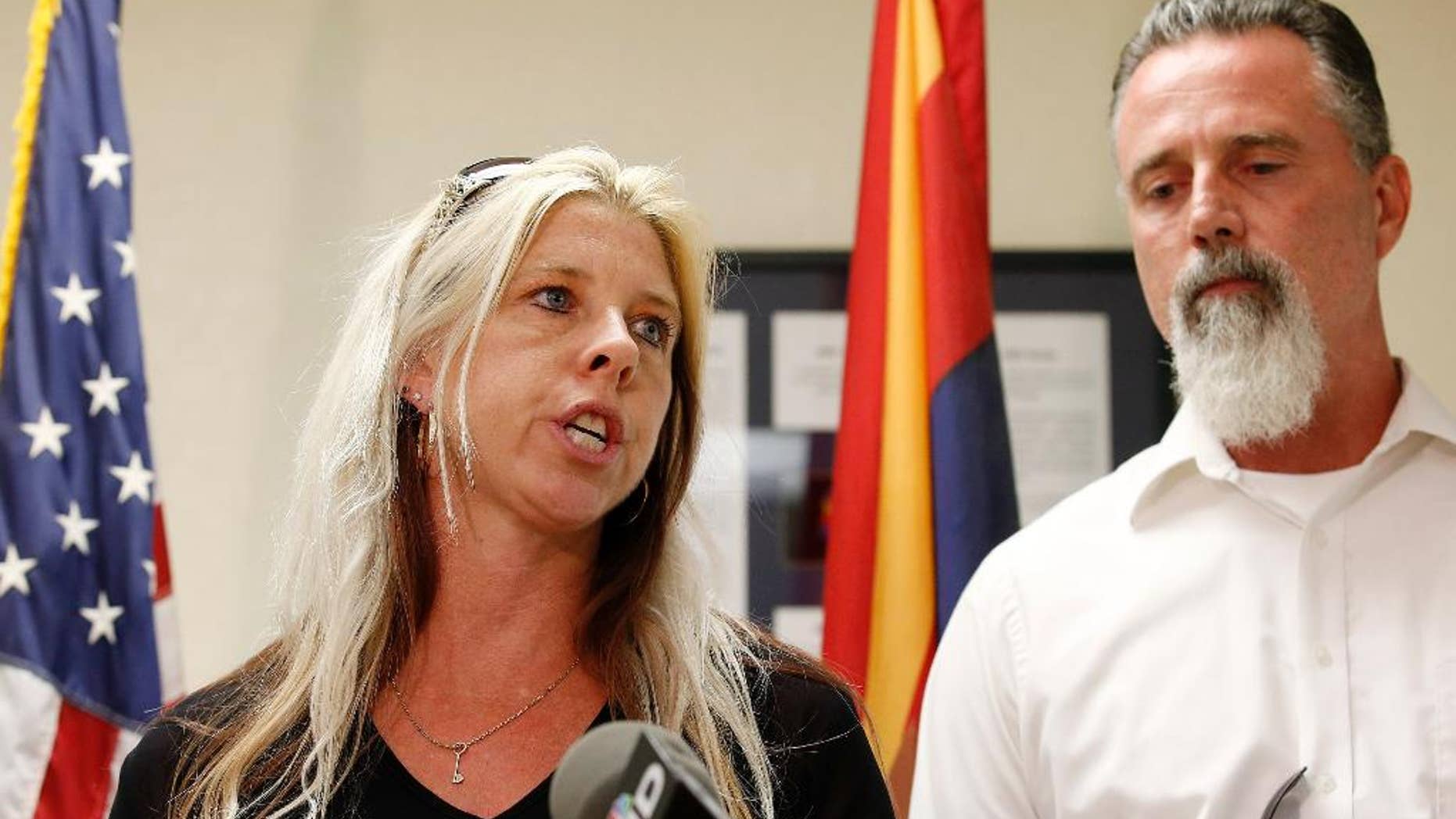 Family members of the victims, Jeanne Brown, left, who had a sister and father murdered, speaks during a news conference as her husband Richard Brown listens, after the nearly two hour long execution of Joseph Rudolph Wood at the state prison on Wednesday, July 23, 2014, in Florence, Ariz. (AP Photo)