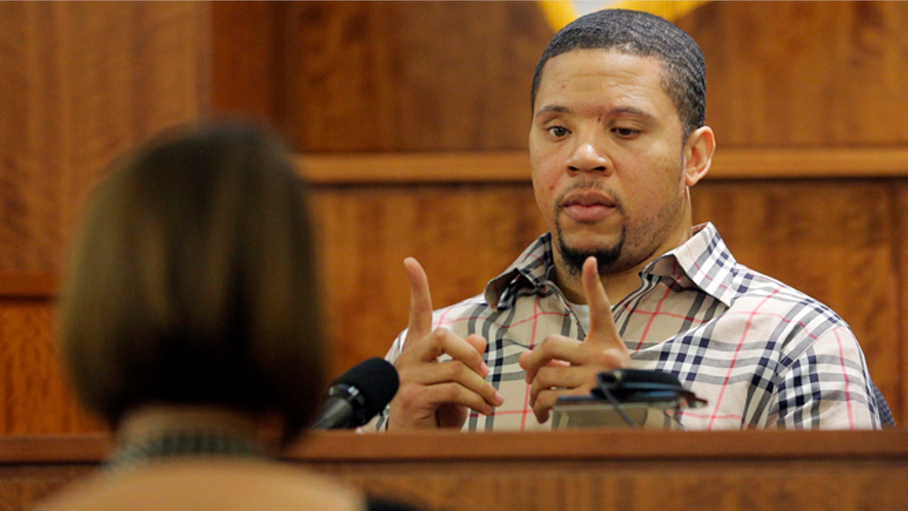 Prosecution witness Alexander Bradley describes a gun he saw with former New England Patriots NFL football player Aaron Hernandez on a trip to Florida as Bradley testifies during Hernandez's murder trial, Wednesday, April 1, 2015, at Bristol County Superior Court in Fall River, Mass. Hernandez is accused of killing Odin Lloyd in June 2013. (AP Photo/Brian Snyder, Pool)