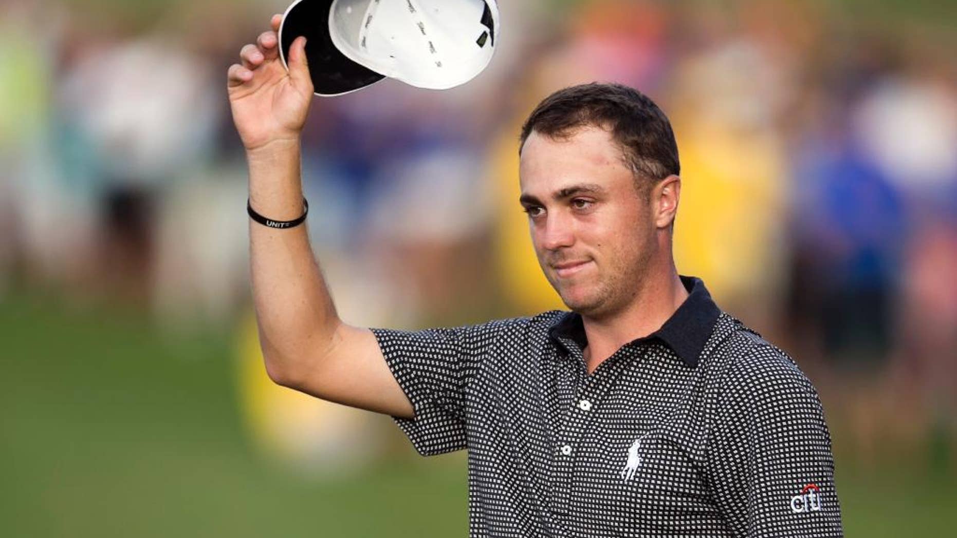 FILE - In this Jan. 15, 2017, file photo, Justin Thomas acknowledges to the gallery after winning the Sony Open golf tournament in Honolulu. Thomas is set to play in the Waste Management Phoenix Open this week, coming off a two-break after a dominating Hawaiian sweep. (AP Photo/Marco Garcia, File)