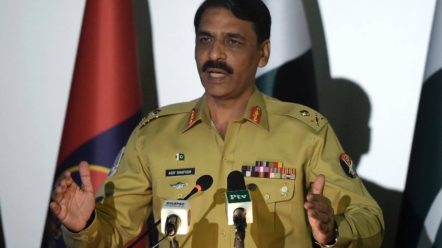 FILE - In this Monday, April 17, 2017 file photo Pakistan's army spokesman Maj. Gen. Asif Ghafoor addresses a news conference in Rawalpindi, Pakistan. Pakistan's military backed off on Wednesday, May 10 after publicly questioning the prime minister's decision to sack an adviser over an explosive newspaper article alleging a rift between the country's civilian government and the military. (AP Photo/Anjum Naveed,file)