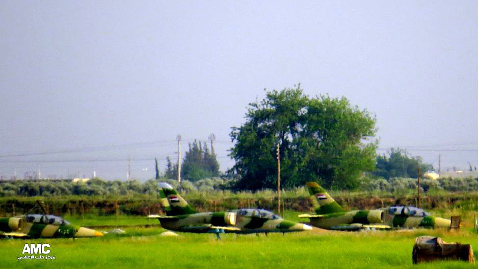 This citizen journalism image provided by Aleppo Media Center AMC which has been authenticated based on its contents and other AP reporting, shows planes on the ground at the Kweiras military air base in Aleppo province, Syria, Sunday, May. 5, 2013. Syrian Observatory for Human Rights said rebels moved deep inside Mannagh air base, near the border with Turkey, while under fire from government warplanes. (AP Photo/Aleppo Media Center AMC)
