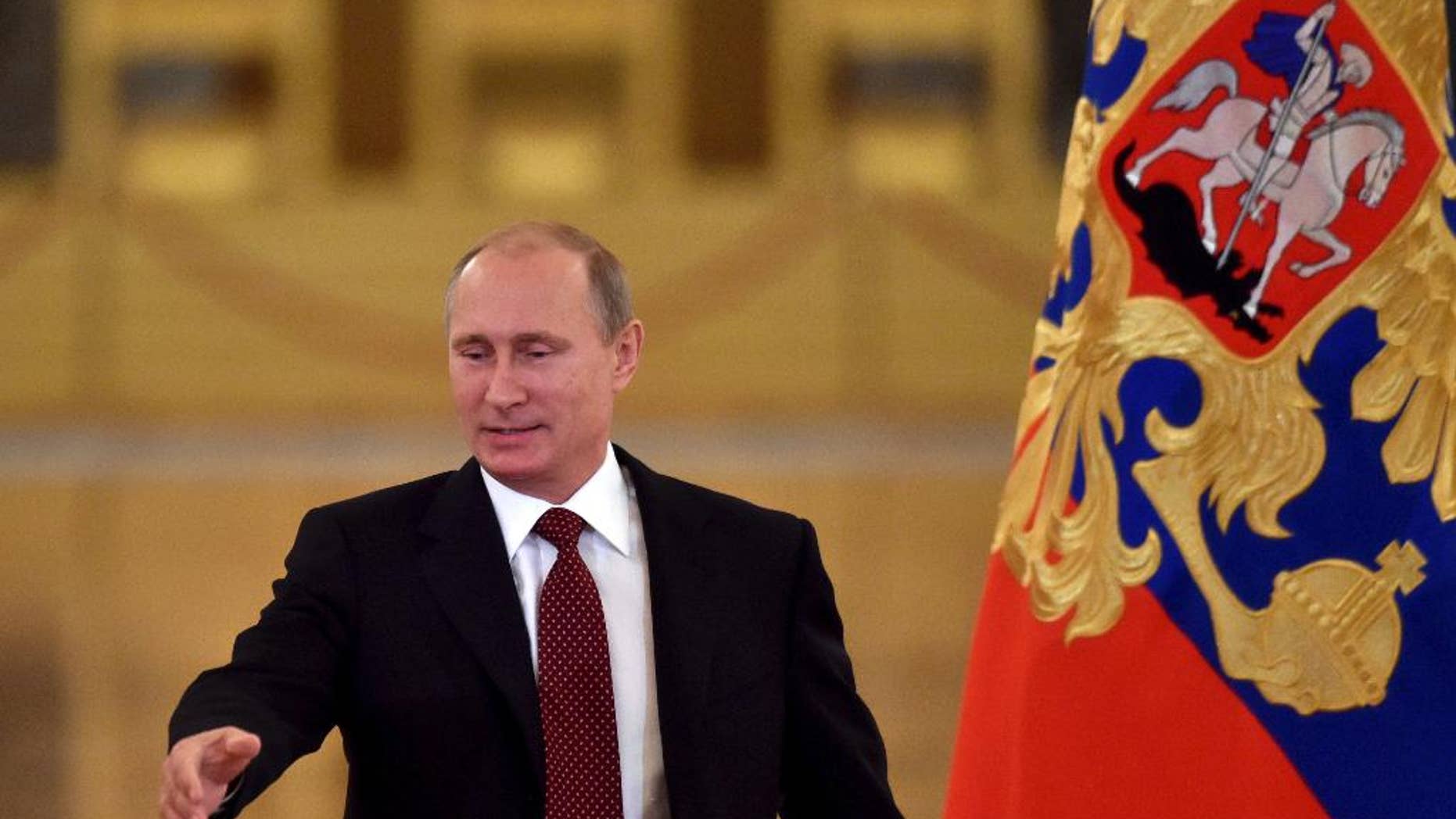 Russian President Vladimir Putin arrives prior to heading the Human Rights Council in Moscow's Kremlin, Russia, Tuesday, Oct. 14, 2014. (AP Photo/Kirill Kydryavtsev, Pool)