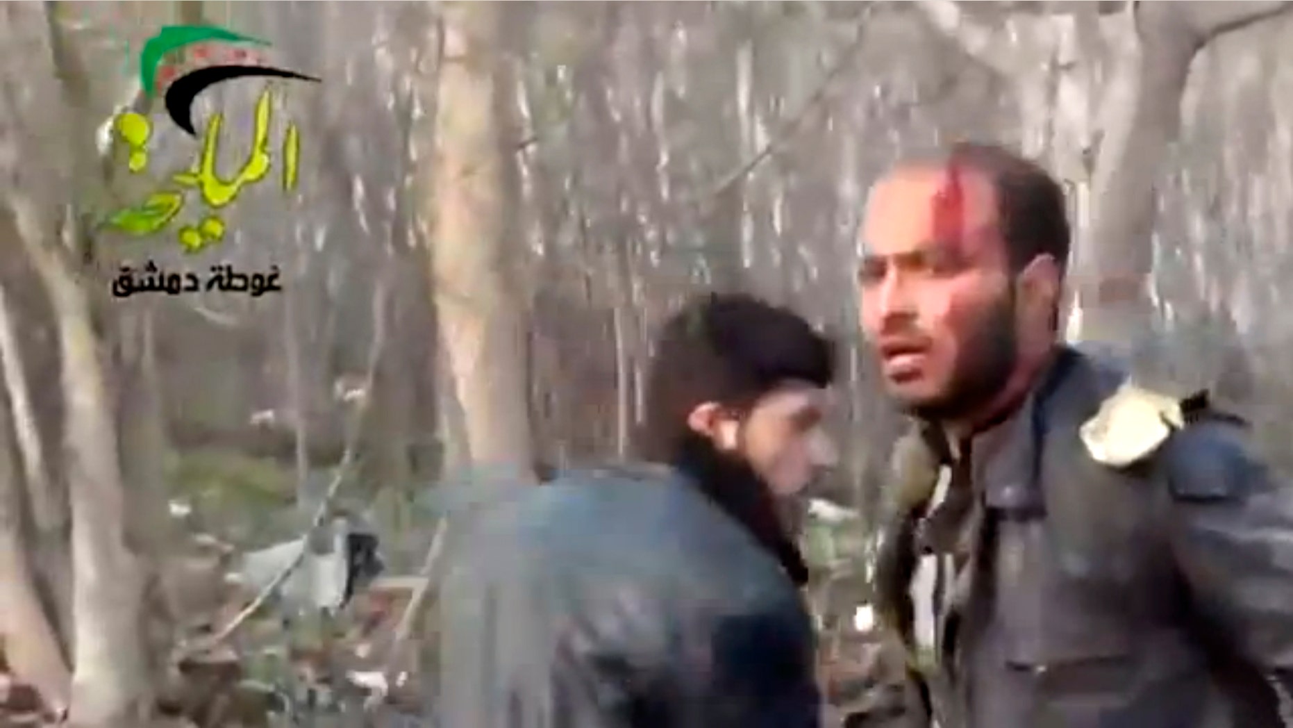 This citizen journalism image taken from video provided by Shaam News Network, which has been authenticated based on its contents and other AP reporting, shows a wounded man at the site of a Syrian government airstrike on a gas station in the eastern Damascus suburb of Mleiha, Syria, Wednesday, Jan. 2, 2013. Activists say dozens of people have been killed or wounded in an air raid on a gas station near the capital Damascus. (AP Photo/Shaam News Network via AP video)