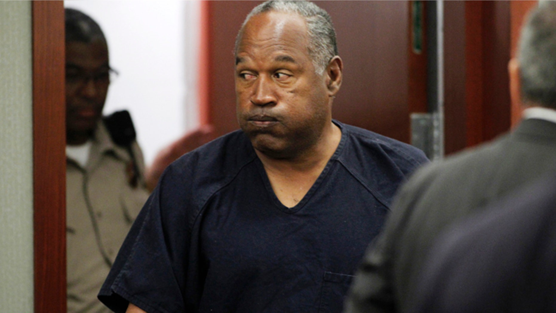 O.J. Simpson returns to the courtroom after a lunch break during the fifth day of an evidentiary hearing in Clark County District Court in Las Vegas, Nevada May 17, 2013. Simpson, who is currently serving a nine-to-33-year sentence in state prison as a result of his October 2008 conviction for armed robbery and kidnapping charges, is using a writ of habeas corpus to seek a new trial, claiming he had such bad representation that his conviction should be reversed. REUTERS/Steve Marcus (UNITED STATES - Tags: CRIME LAW SPORT ENTERTAINMENT) - RTXZR2N