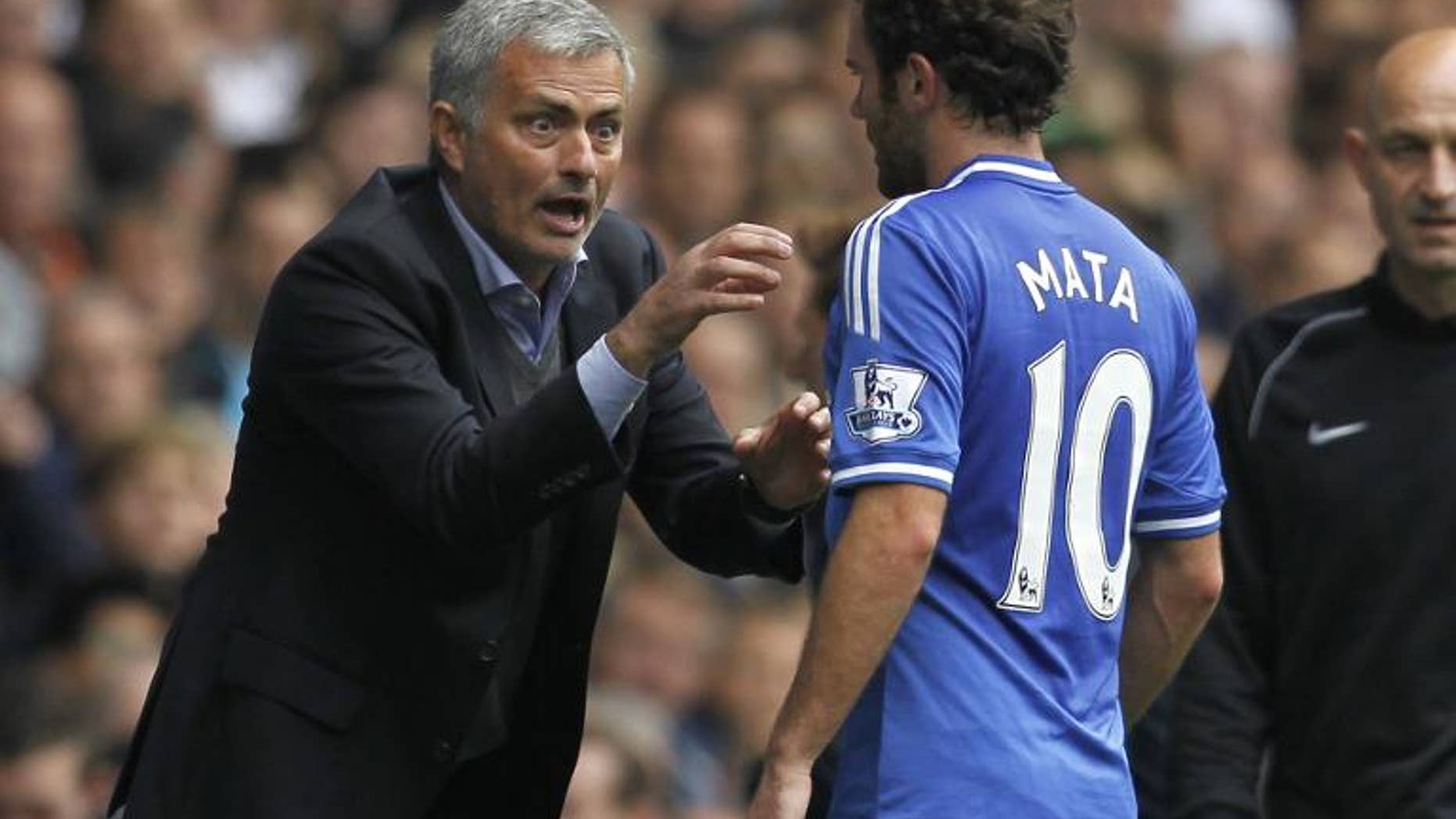 Chelsea's Portuguese manager Jose Mourinho (left) gestures to Juan Mata during a match with Tottenham Hotspur at White Hart Lane on September 28, 2013