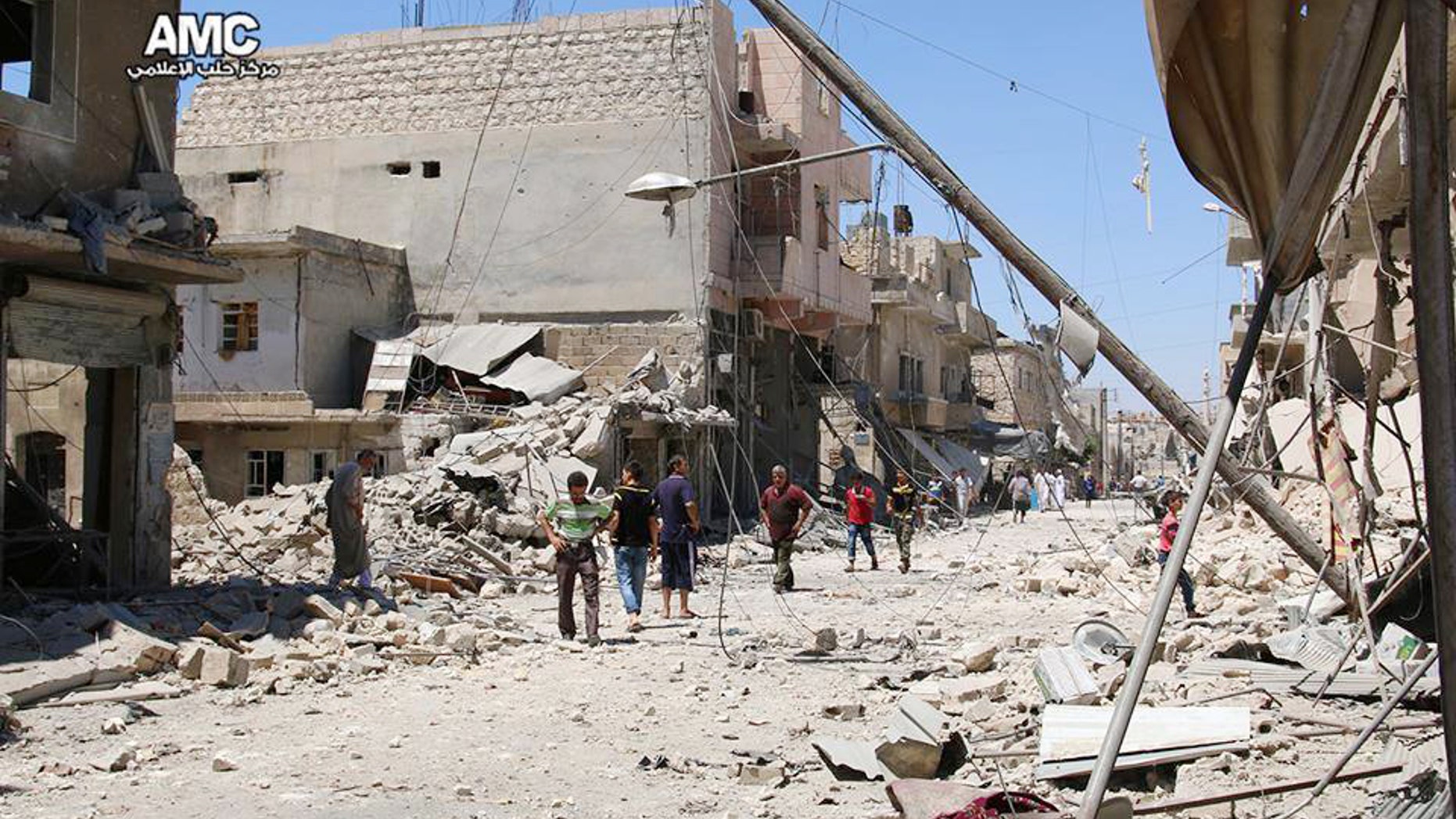 FILE - n this Wednesday, July. 27, 2016 photo, provided by the Syrian anti-government activist group Aleppo Media Center (AMC), shows Syrian citizens inspect damaged buildings after airstrikes hit Aleppo, Syria.