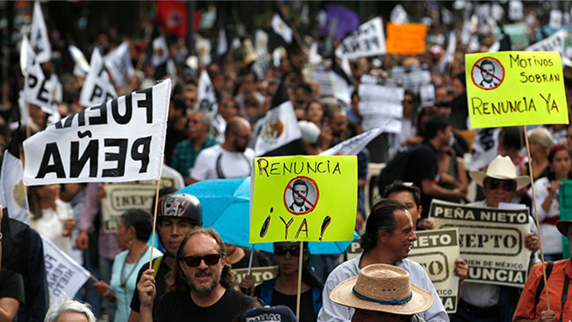 People march to demand the resignation of Mexico's President Enrique Pena Nieto in Mexico City, Thursday, Sept. 15, 2016, one day before the country's independence day. (AP Photo/Eduardo Verdugo)