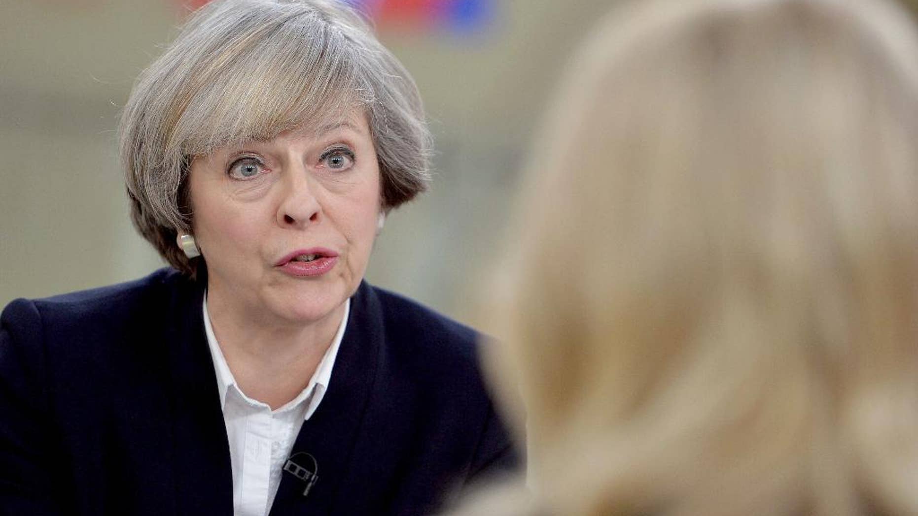 Britain's Prime Minister Theresa May, left, is interviewed by Sophy Ridge for a television channel, in London, Sunday Jan. 8, 2017. May said Sunday she will announce details of Britain's European Union exit plans in the next few weeks, and denied a former diplomat's claim that the government is "muddled" about Brexit. (John Stillwell/PA via AP)