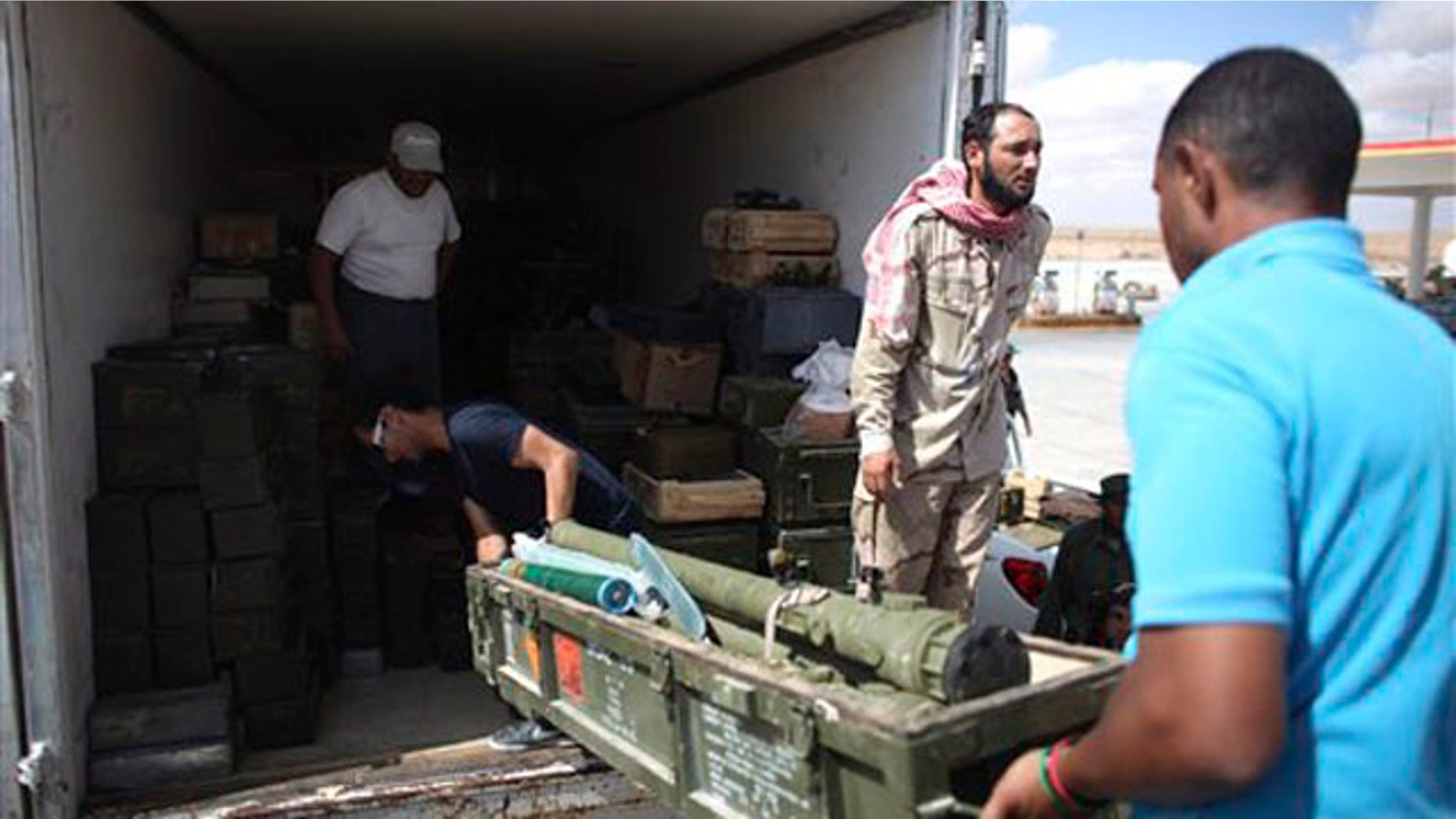 Rebels unload ammunition from a truck in Wish Tata, Libya, Friday, Sept. 9, 2011.