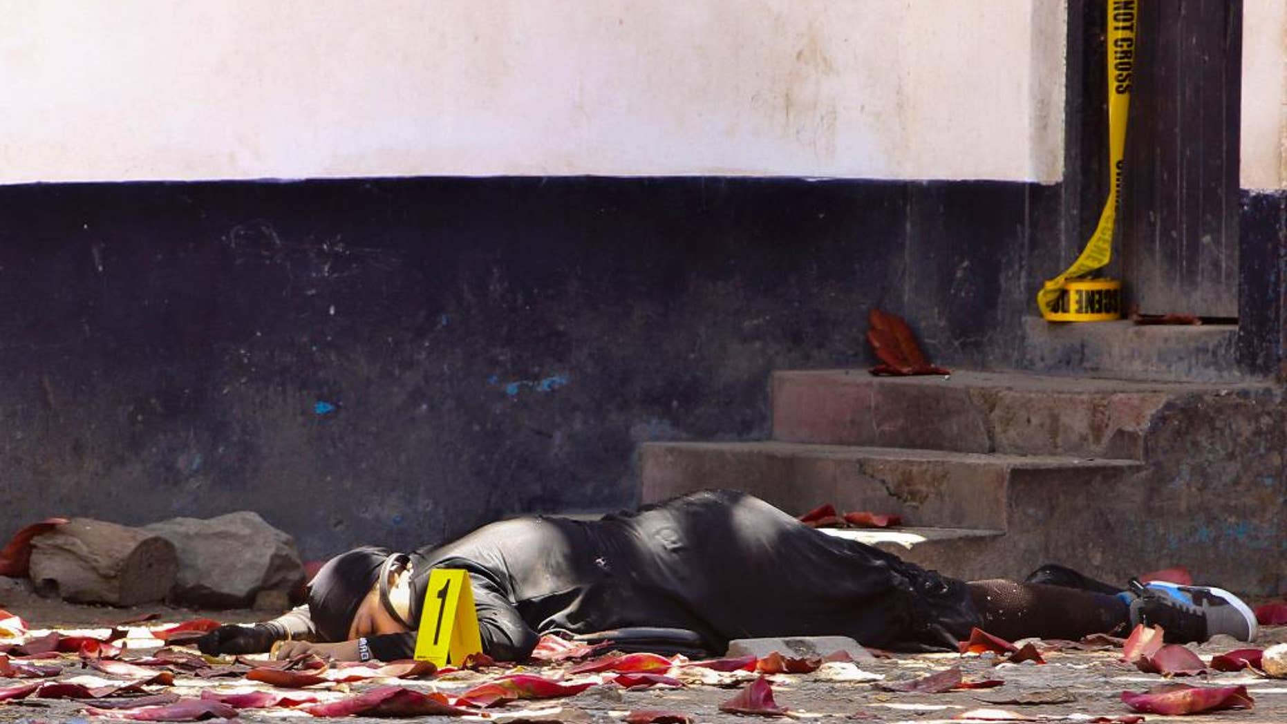 FILE- In this file photo dated Sunday Sept.11, 2016, one of the bodies of three women who were shot dead by police, outside the central police station in the coastal city of Mombasa, Kenya. Human rights activists with the Muslims for Human Rights group, on Friday Sept. 23, 2016, accused Kenyan police of executing three women who allegedly attacked a police station this month after pledging allegiance to the Islamic State group. (AP Photo / FILE)