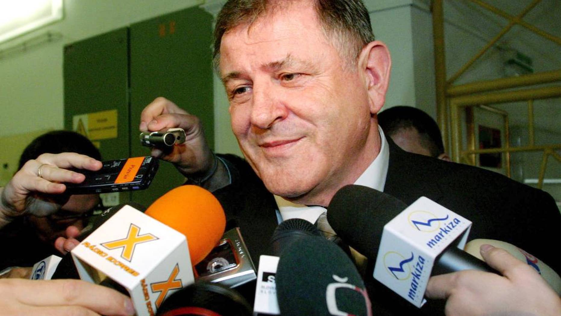 FILE- In this Saturday April 17, 2004 file photo, the then Slovak presidential candidate and former Prime Minister Vladimir Meciar speaks to the media after casting his vote during elections in downtown Bratislava, Slovakia. Slovakia’s parliament has started to debate a proposal to annul pardons by former authoritarian Prime Minister Vladimir Meciar that prevent an investigation into the kidnapping of the son of late President Michal Kovac, Meciar's political archrival. A vote is expected on Thursday, March 30, 2017. (AP Photo/Petr David Josek, File)