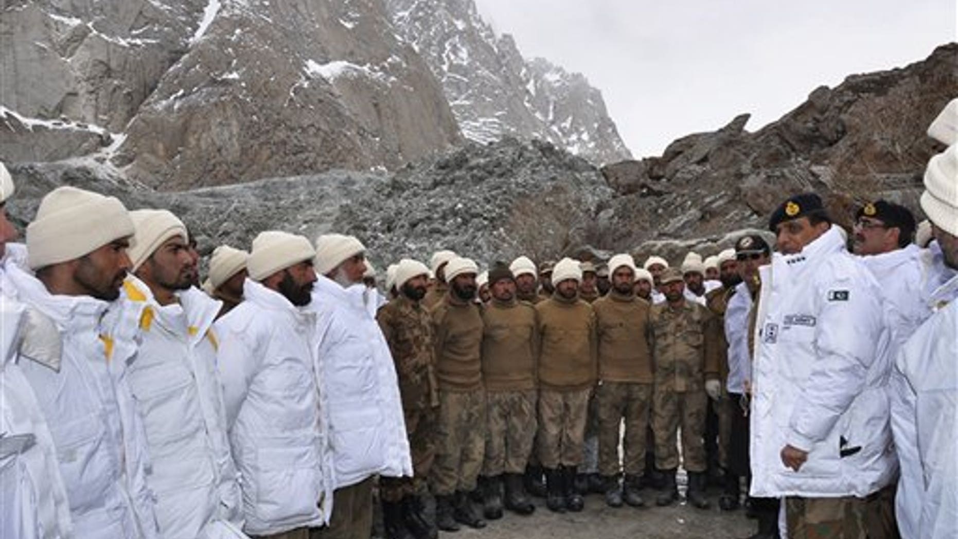 April 8, 2012: In this photo released by Inter Services Public Relations, Pakistan's army chief Gen. Ashfaq Parvez Kayani, second right, talks to soldiers during his visit to avalanche incident site in Siachen, in northern Pakistan.