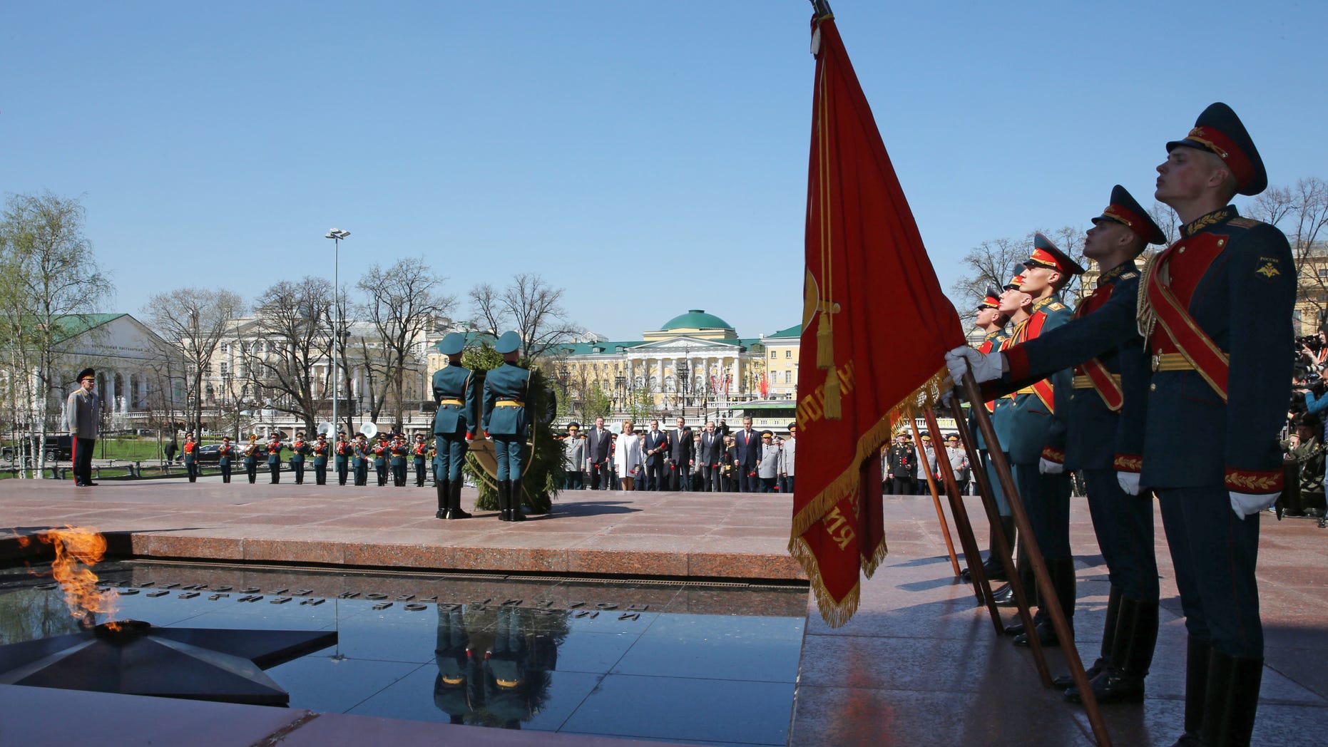 Russian President Vladimir Putin, in the background, takes part in a wreath laying ceremony at the Tomb of Unknown Soldier on the eve of the Victory Day in Moscow, Wednesday, May 8, 2013. President Vladimir Putin attended a ceremony ahead of two days of public holiday and military parades for Victory Day, which remains a significant event on the Russian calendar. (AP Photo/RIA-Novosti, Yekaterina Shtukina, Government Press Service)