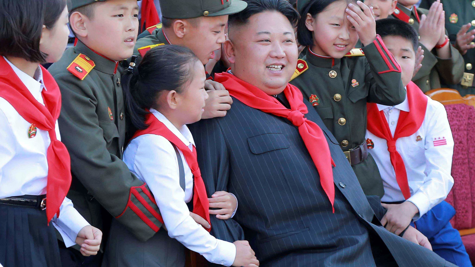 North Korean leader Kim Jong Un poses with participants during the 8th Congress of the Korean Children's Union