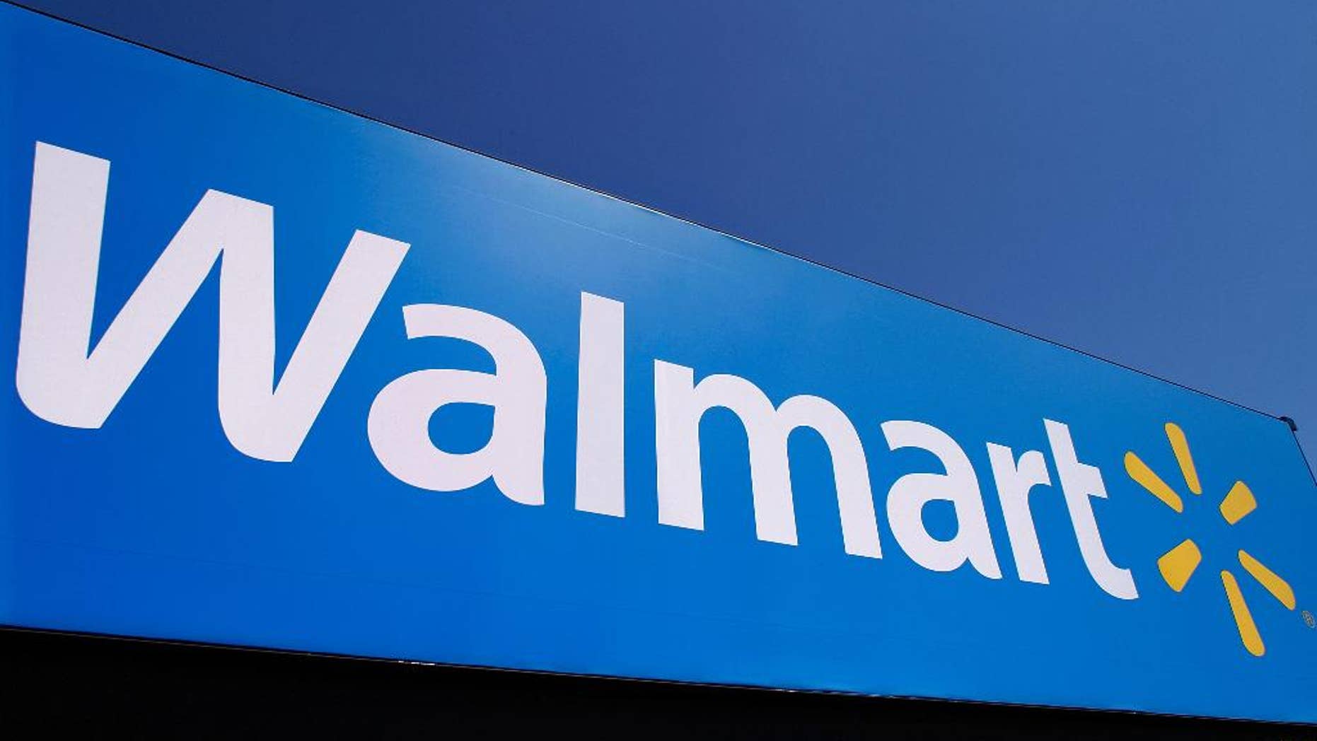 FILE - In this May 16, 2011 file photo, the Walmart logo is displayed on a store in Springfield, Ill. The retail giant won a legal victory Monday, March 28,2 016 in a fight over taxation by Puerto Rico's government when a federal judge in the U.S. island territory ruled that a modified tangible-property tax is invalid. The ruling was issued as the island rushes to find new sources of revenue and a debt restructuring mechanism from the U.S. Congress while struggling through a decade-long economic crisis. The government says it will appeal the decision. (AP Photo/Seth Perlman, File)