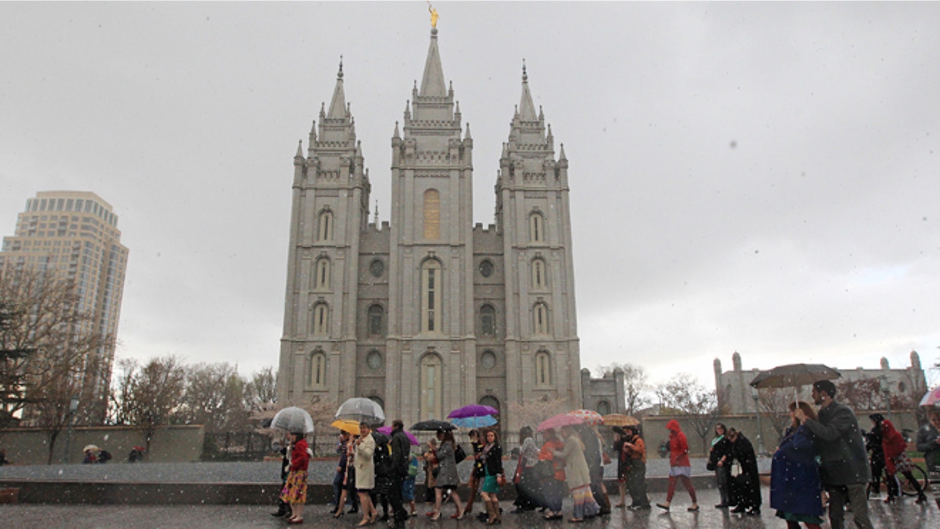 This April 5, 2013 photo, a Mormon's women group pushing the church to allow women in the priesthood march to Temple Square during the two-day Mormon church conference in Salt lake City. The expanding international footprint of the Mormon church will be on display this weekend starting Saturday, Oct. 4, 2014, during a conference that brings 100,000 members to Salt Lake City to listen to guidance and inspiration from church leaders. Thousands of the attendees will be coming from countries outside the U.S., and it is widely anticipated that one of this weekend's speakers will deliver an address in a language other than English. (AP Photo/Rick Bowmer)