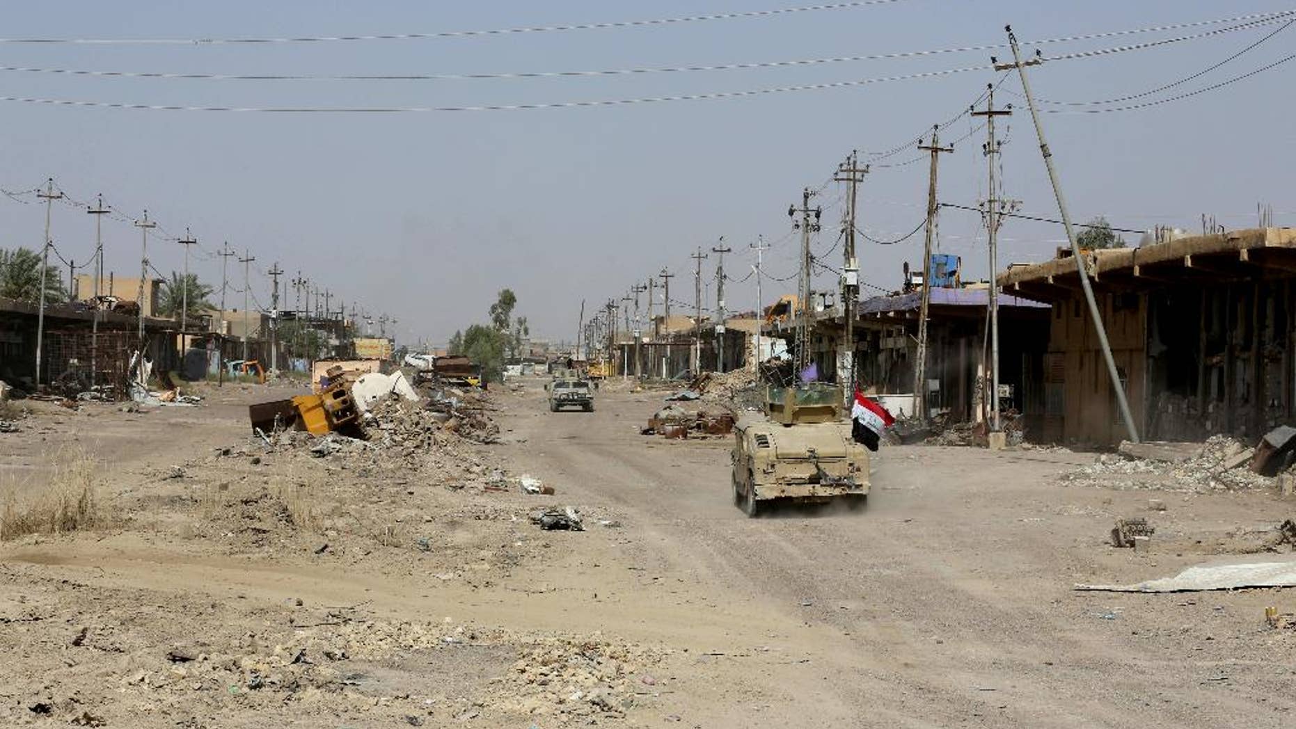 In this Wednesday, June 22, 2016 photo, Iraqi forces advance in Fallujah, Iraq. On the northwestern edge of Fallujah, Iraqi commanders are preparing for one of their toughest battles yet, despite declaring victory in the city west of Baghdad last week.(AP Photo/Hadi Mizban)