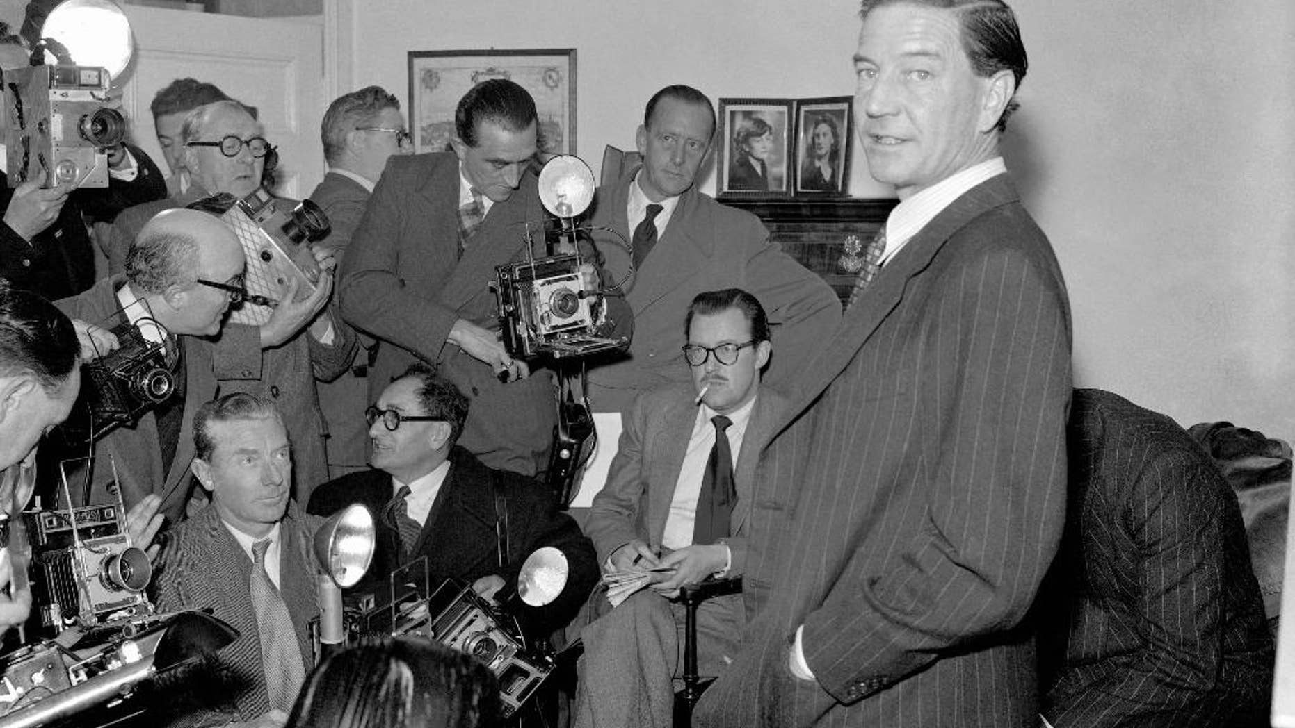 FILE - In this file photo dated Nov. 8, 1955, former British diplomat who was at that time accused of spying for Russia, during a press conference at his parents' home in London on Nov. 8, 1955. In a 1981 film posted online Monday April 4, 2016, by the BBC, notorious British spy Kim Philby is shown in newly uncovered footage addressing East German spies, "comrades", about his life as a double agent secretly helping the Soviet Union, in what is the closest thing to a full confession yet to surface. Philby died in 1988 in his adopted Soviet homeland. (AP Photo/FILE)