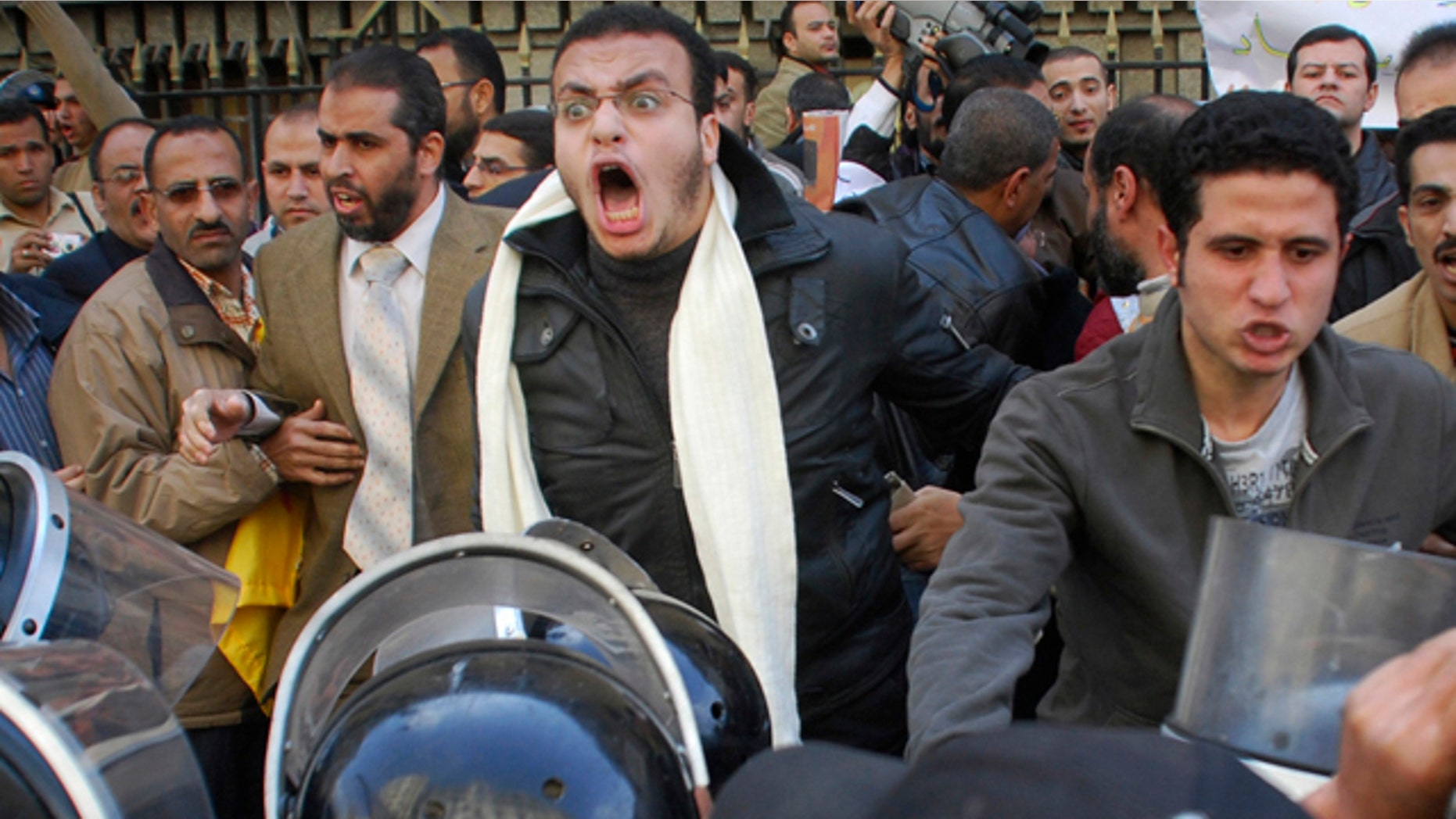 Jan. 25: Protesters are confronted by riot police as they demonstrate in downtown Cairo, Egypt.