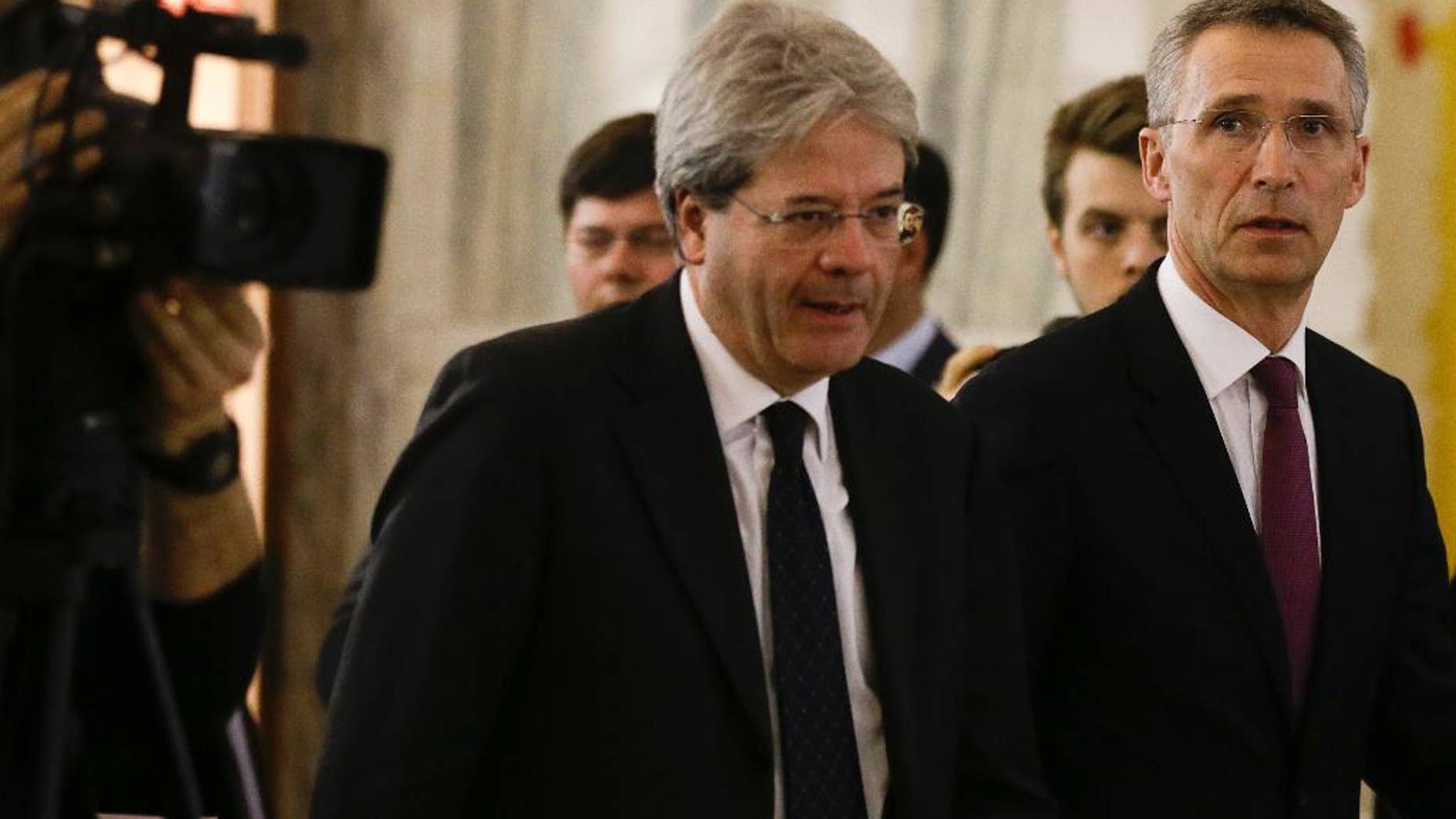 NATO Secretary General Jens Stoltenberg, right, and Italian Foreign Minister Paolo Gentiloni arrive for a joint press conference at the end of their meeting at the Foreign Ministry in Rome, Thursday, Feb. 26, 2015. (AP Photo/Gregorio Borgia)