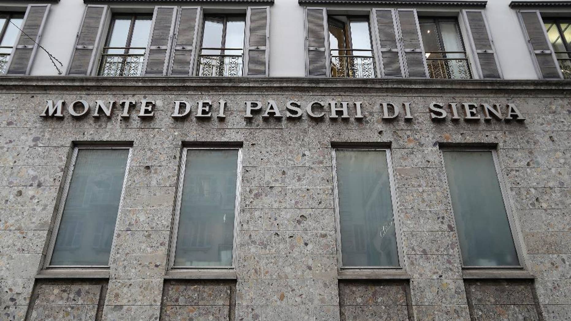 FILE - In this file photo dated Monday, Dec. 19, 2016, the facade of a branch of the ' Monte Dei Paschi di Siena ' bank in Milan, Italy. In a statement issued late Monday Dec. 27, 2016, the European Central Bank estimates the Monte Dei Paschi di Siena bank will need more rescue money than previously expected. (AP Photo/Antonio Calanni, FILE)