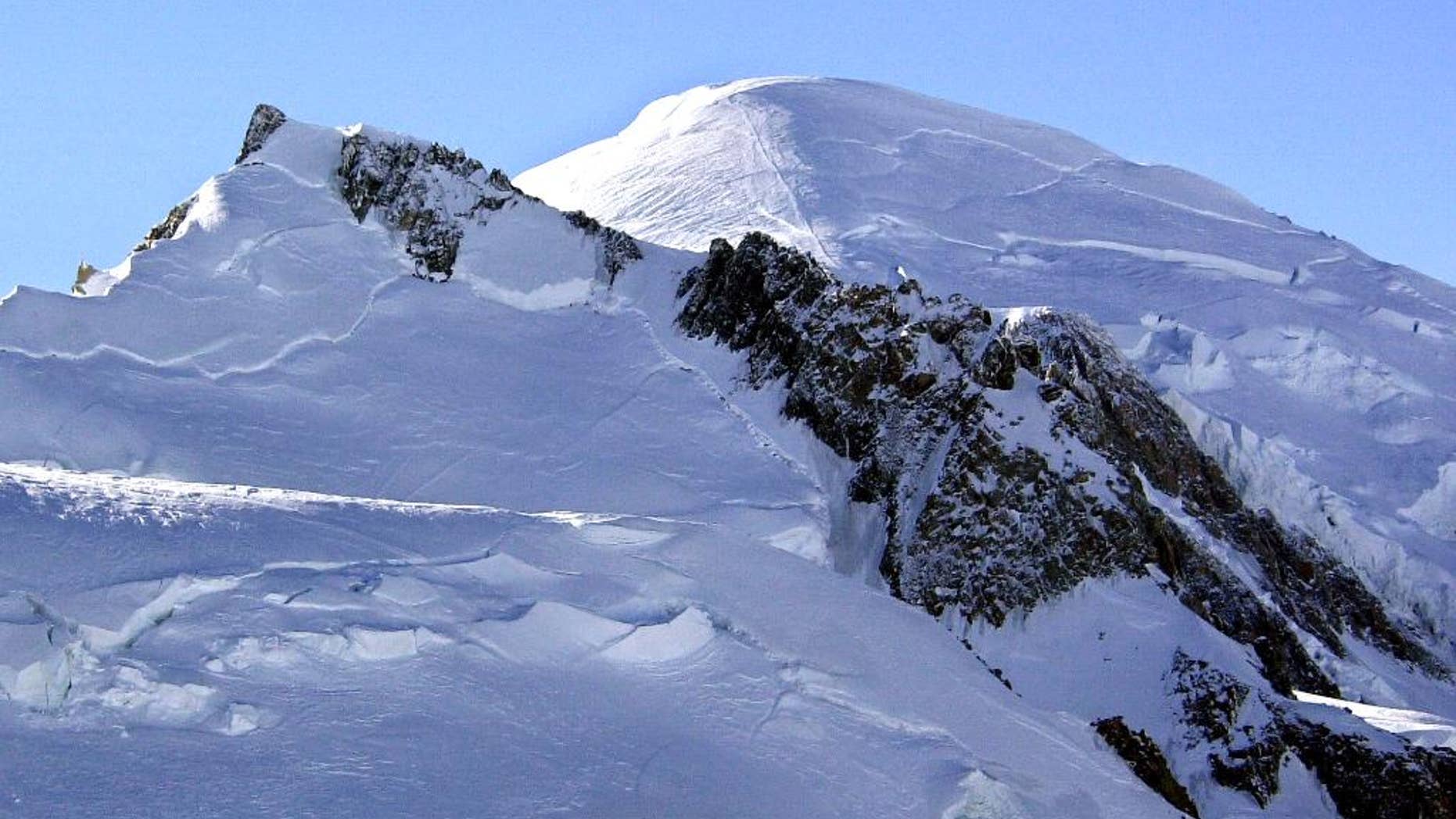 FILE - This Feb. 19, 2003 file photo shows Mont Blanc, western Europe's highest mountain. The mountain rescue team chief in the French town of Chamonix says Thursday Aug. 18 2016 that two women, a Slovakian and a Polish-British, and their German guide were climbing Mont Blanc's Mont Maudit at 4,100 meters (13,450 feet) when a tower of ice swept over them early Tuesday. The bodies of the three alpinists, have been found and dug out from the thick ice. (AP Photo/Patrick Gardin, File)
