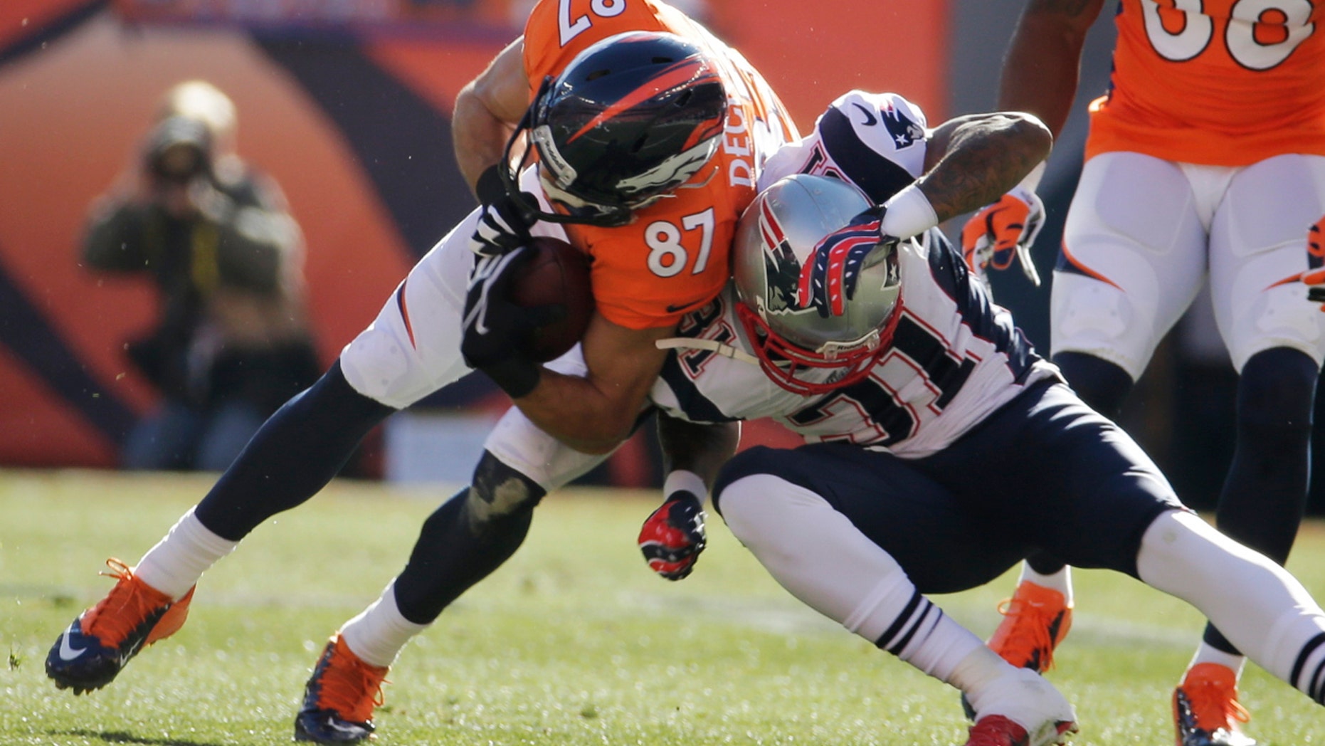 Denver Broncos wide receiver Eric Decker (87) is stopped New England Patriots cornerback Aqib Talib (31) during the first half of the AFC Championship NFL playoff football game in Denver, Sunday, Jan. 19, 2014. (AP Photo/Charlie Riedel)